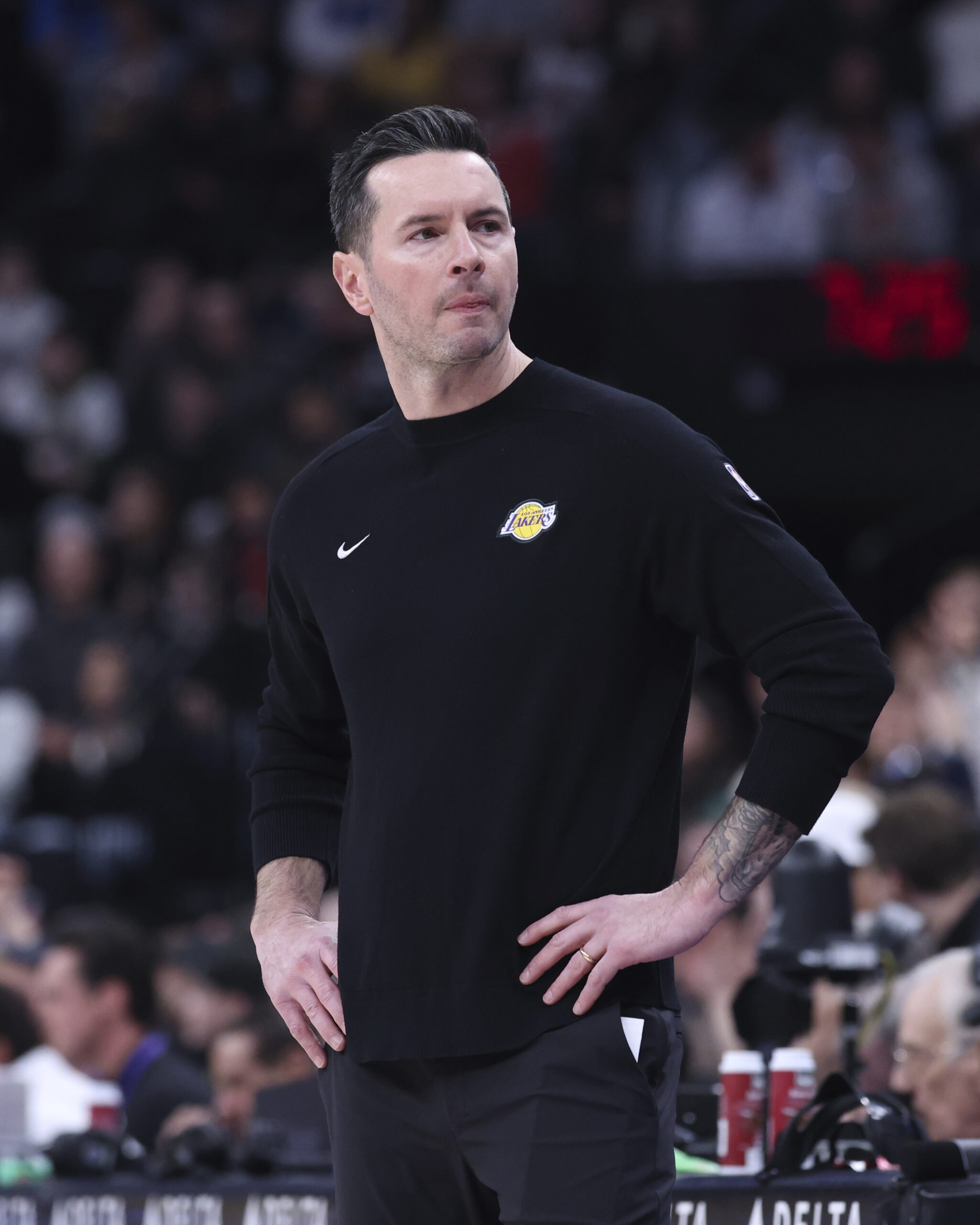 Lakers head coach JJ Redick looks to the bench during...