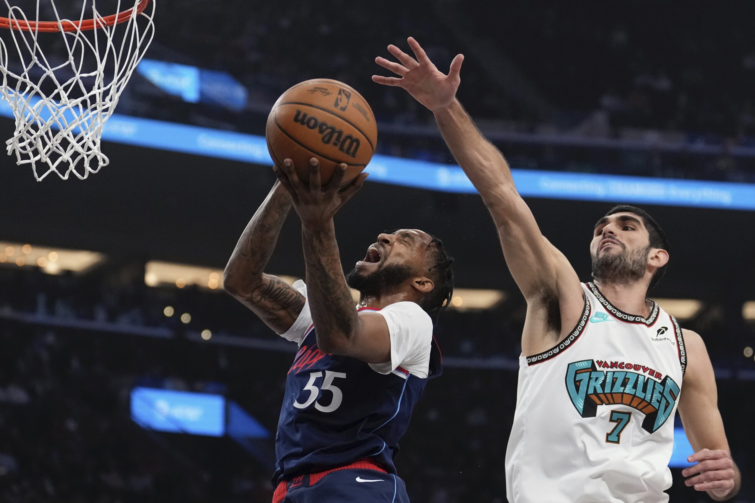 Clippers forward Derrick Jones Jr., left, shoots as Memphis Grizzlies...