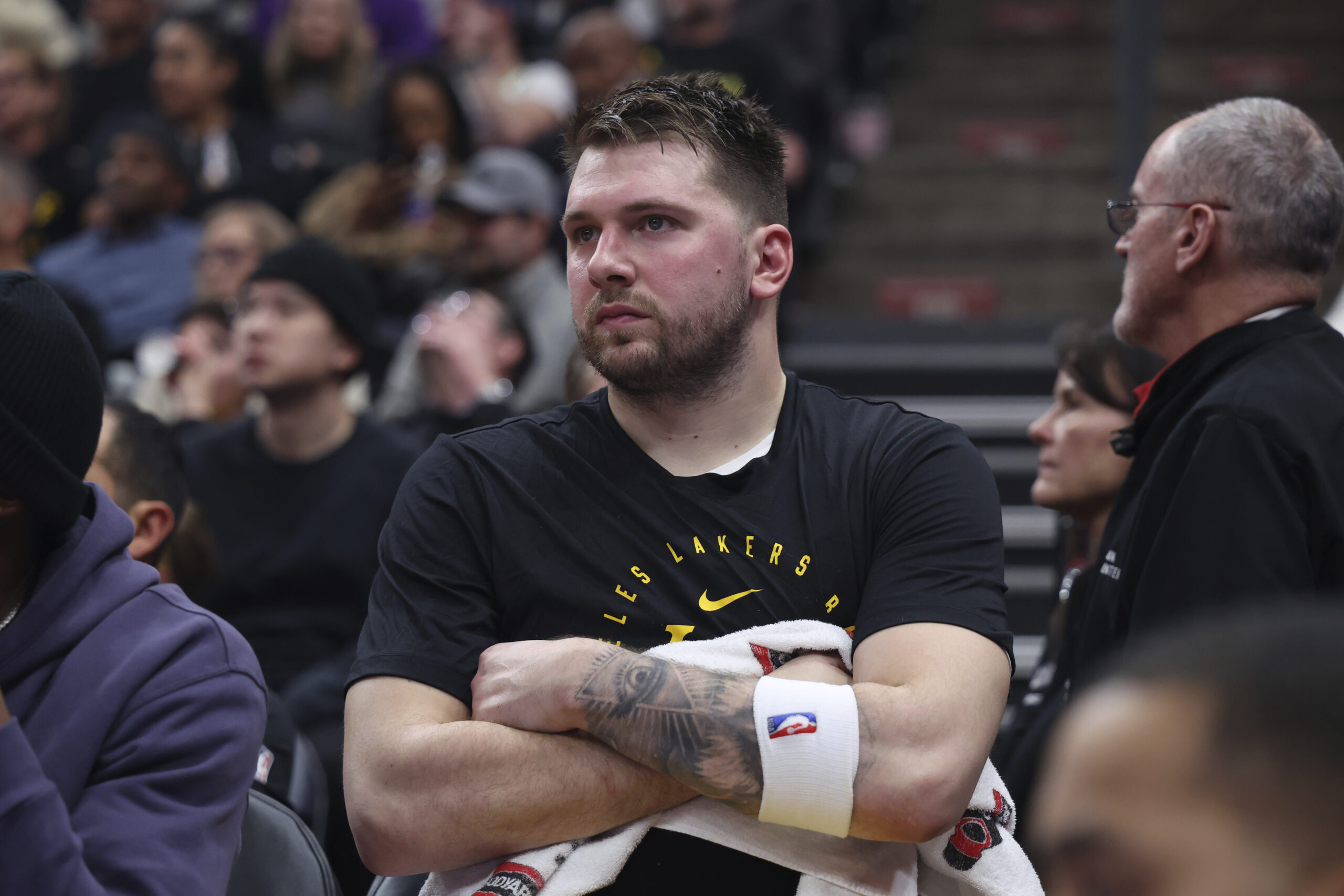 Lakers guard Luka Doncic watches from the bench during the...