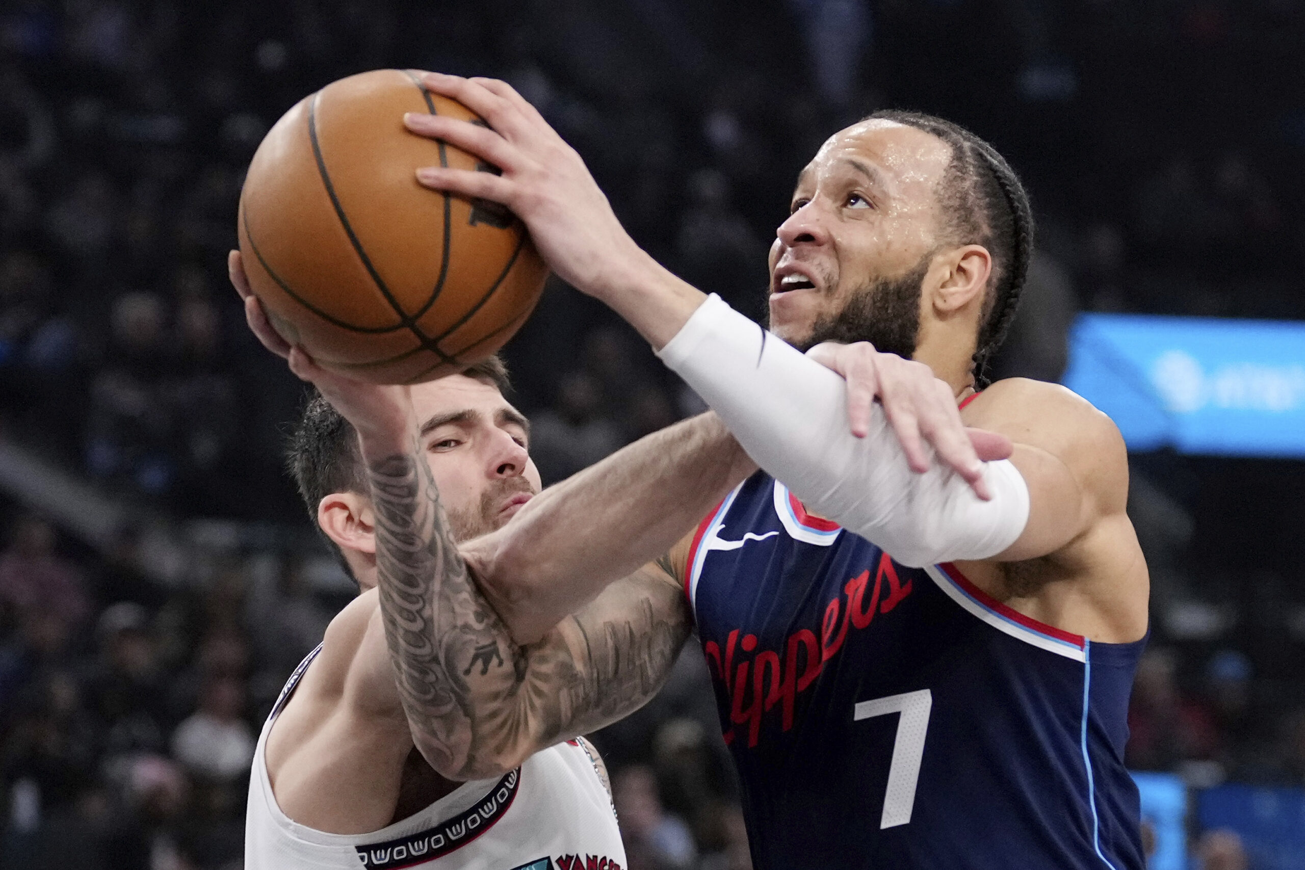 Clippers guard Amir Coffey, right, is fouled as he shoots...