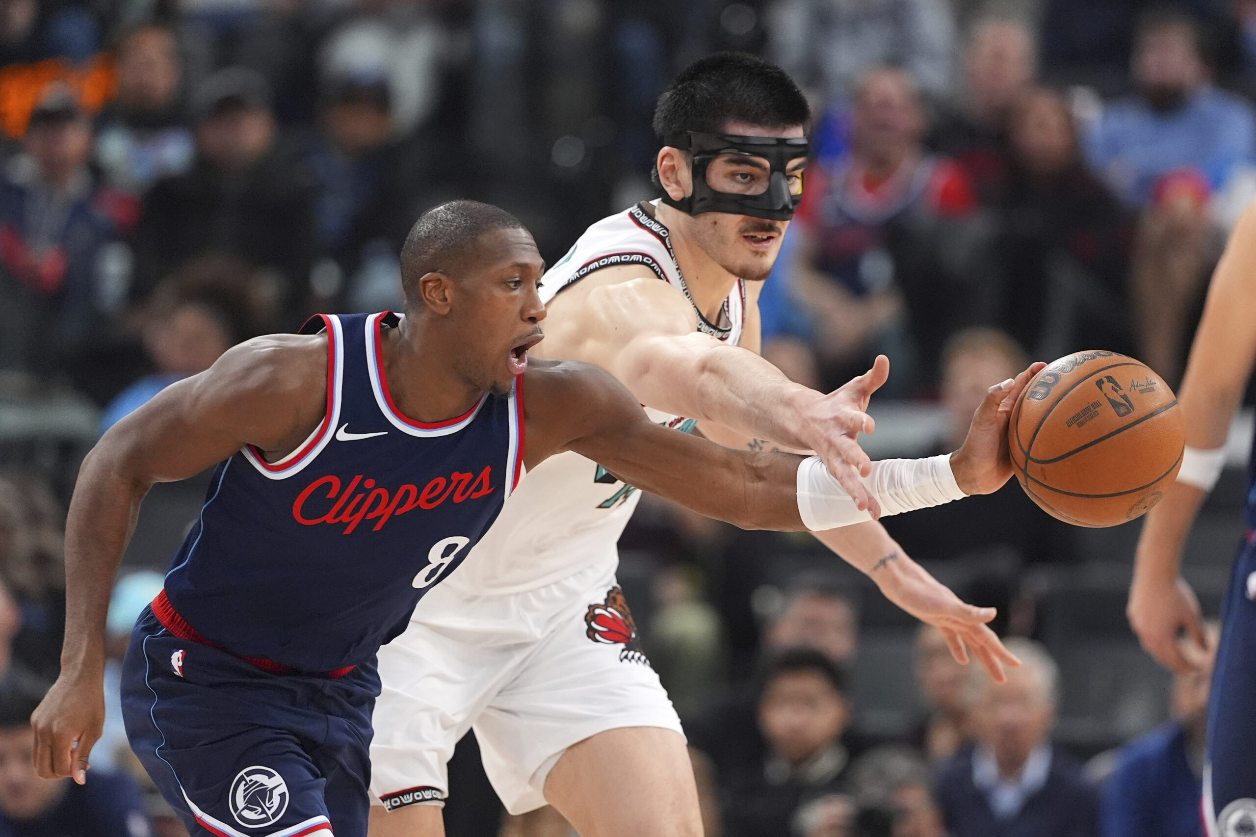 Clippers guard Kris Dunn, left, steals a pass away from...