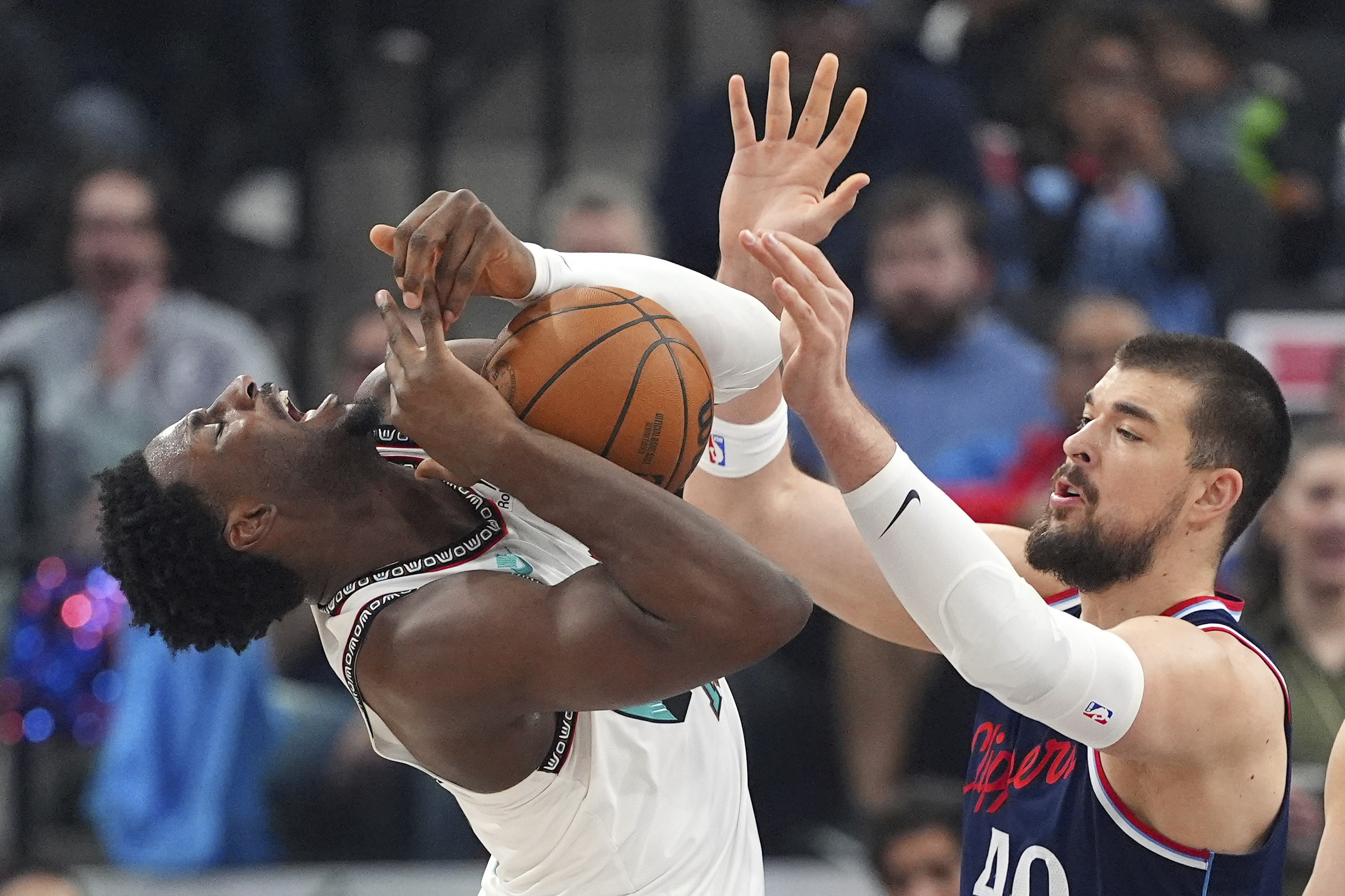 Clippers center Ivica Zubac, right, knocks the ball away from...