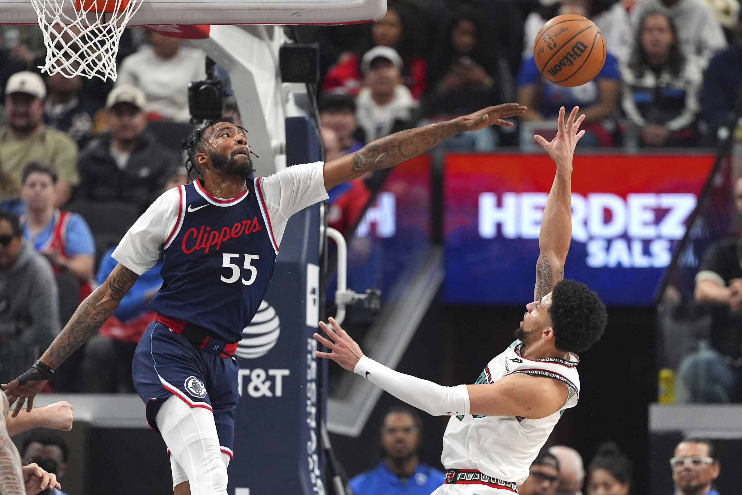 Memphis Grizzlies guard Scotty Pippen Jr., right, shoots as Clippers...