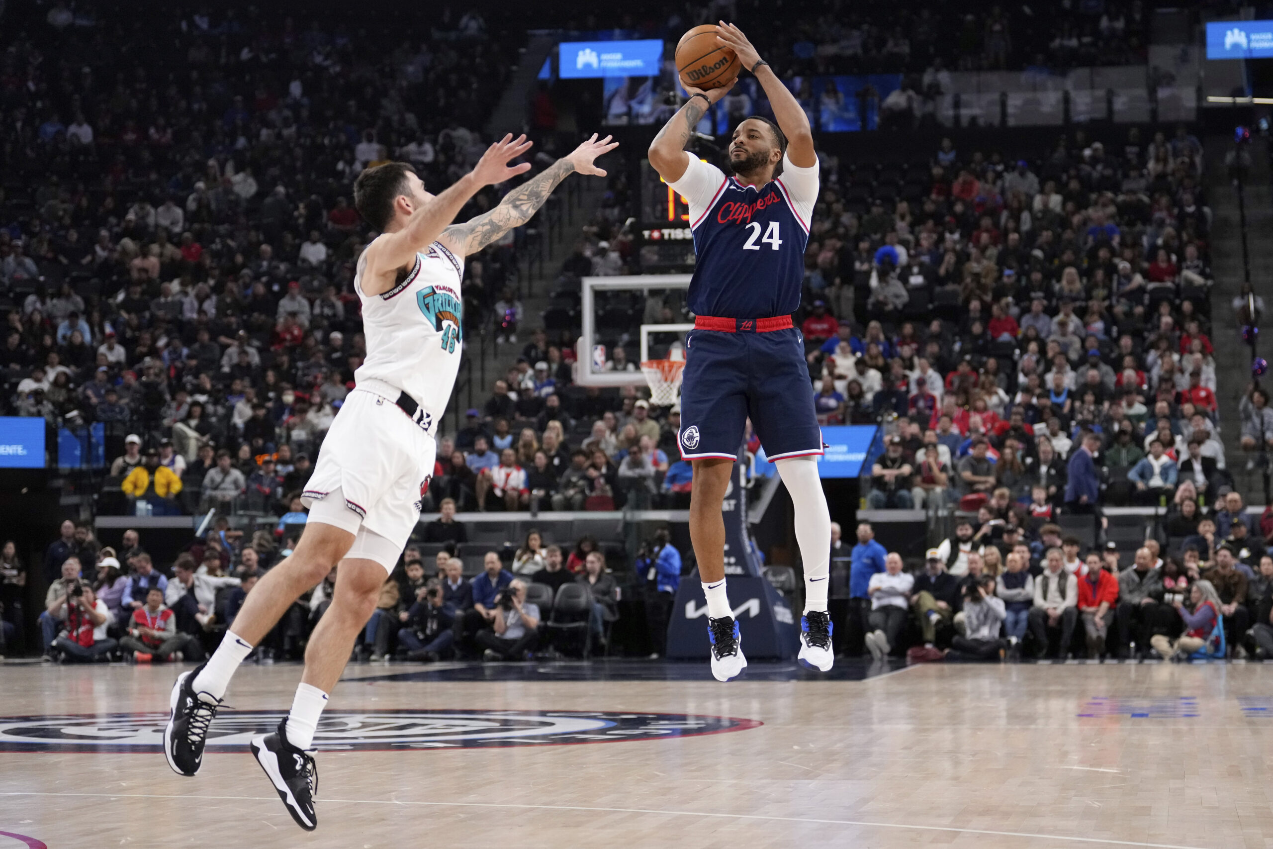 Clippers guard Norman Powell, right, shoots as Memphis Grizzlies guard...