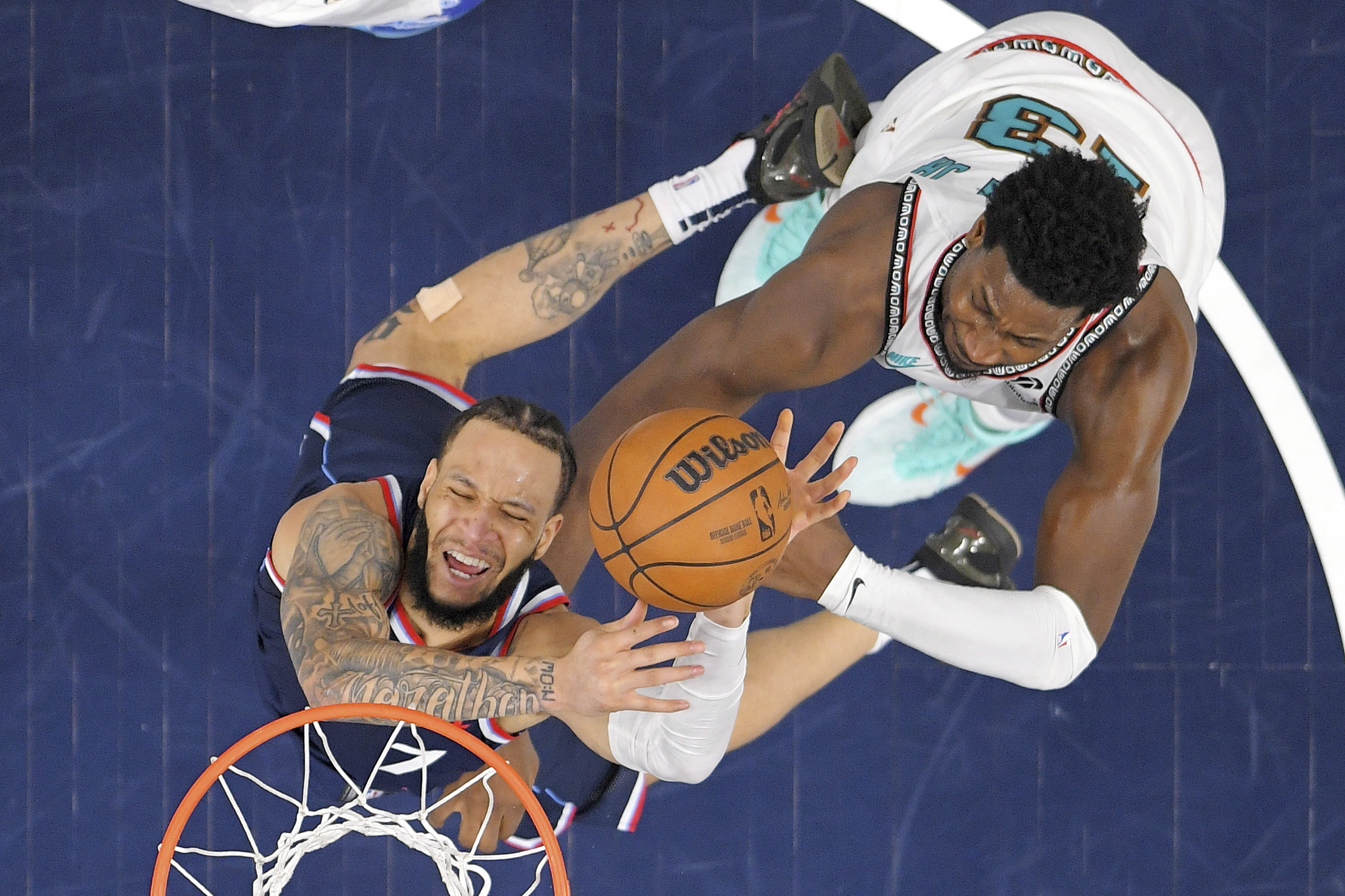 Clippers guard Amir Coffey, left, shoots as Memphis Grizzlies forward...