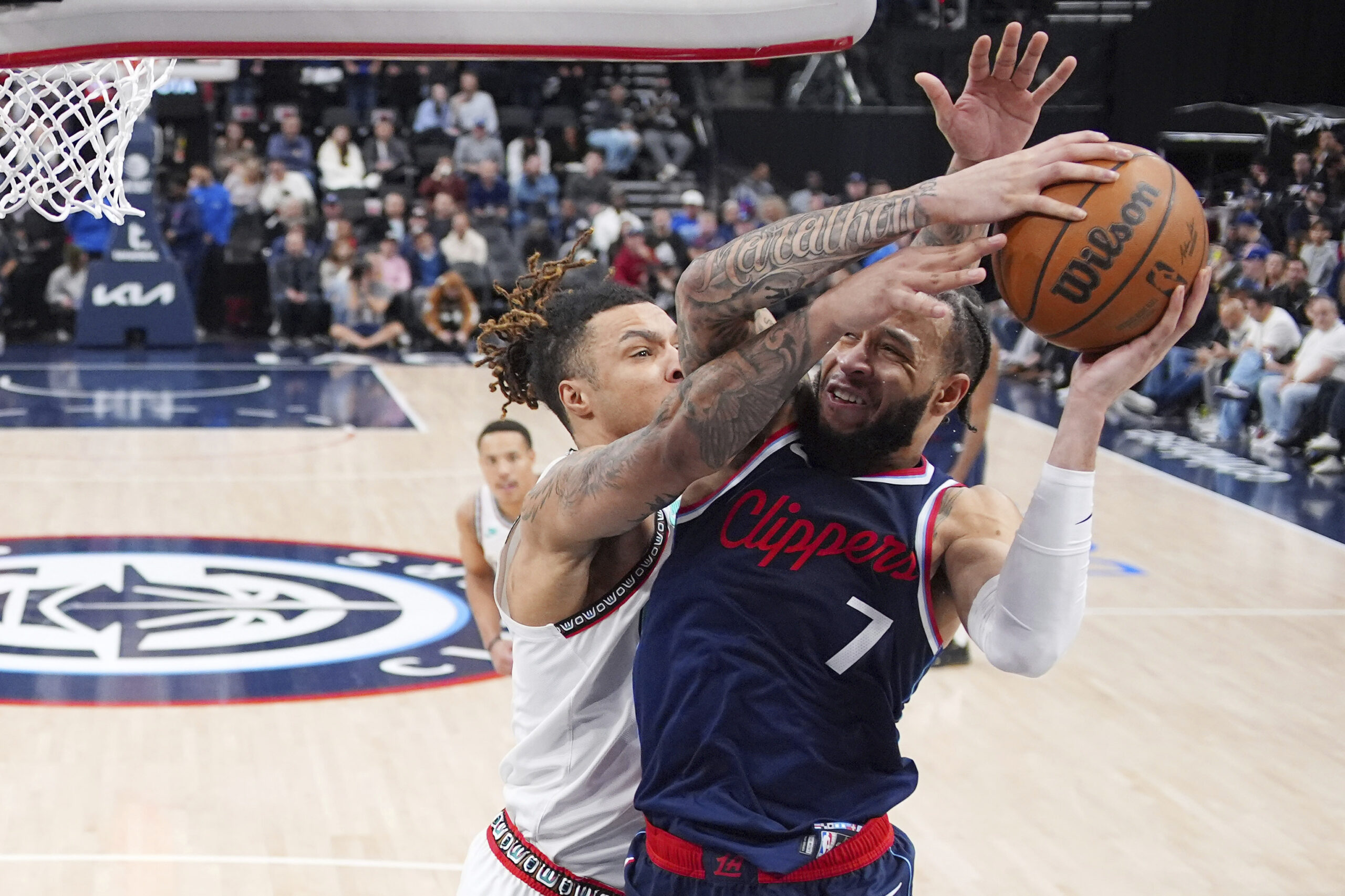 Clippers guard Amir Coffey, right, shoots as Memphis Grizzlies forward...