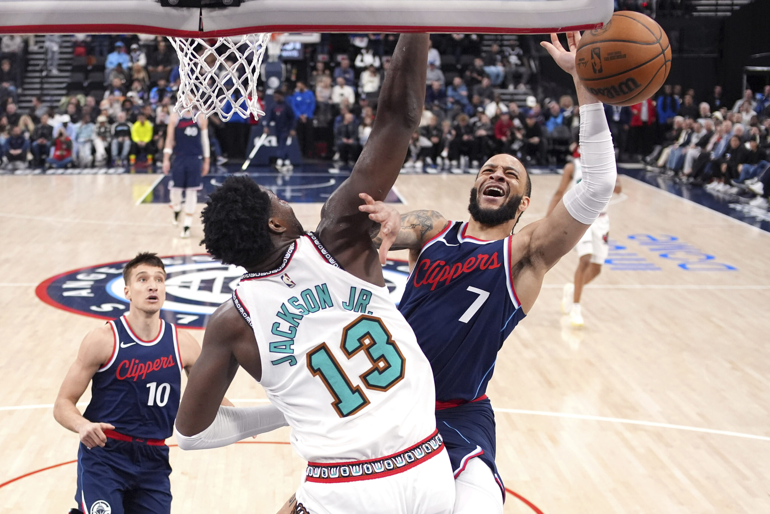 Clippers guard Amir Coffey, right, tries to shoot as Memphis...