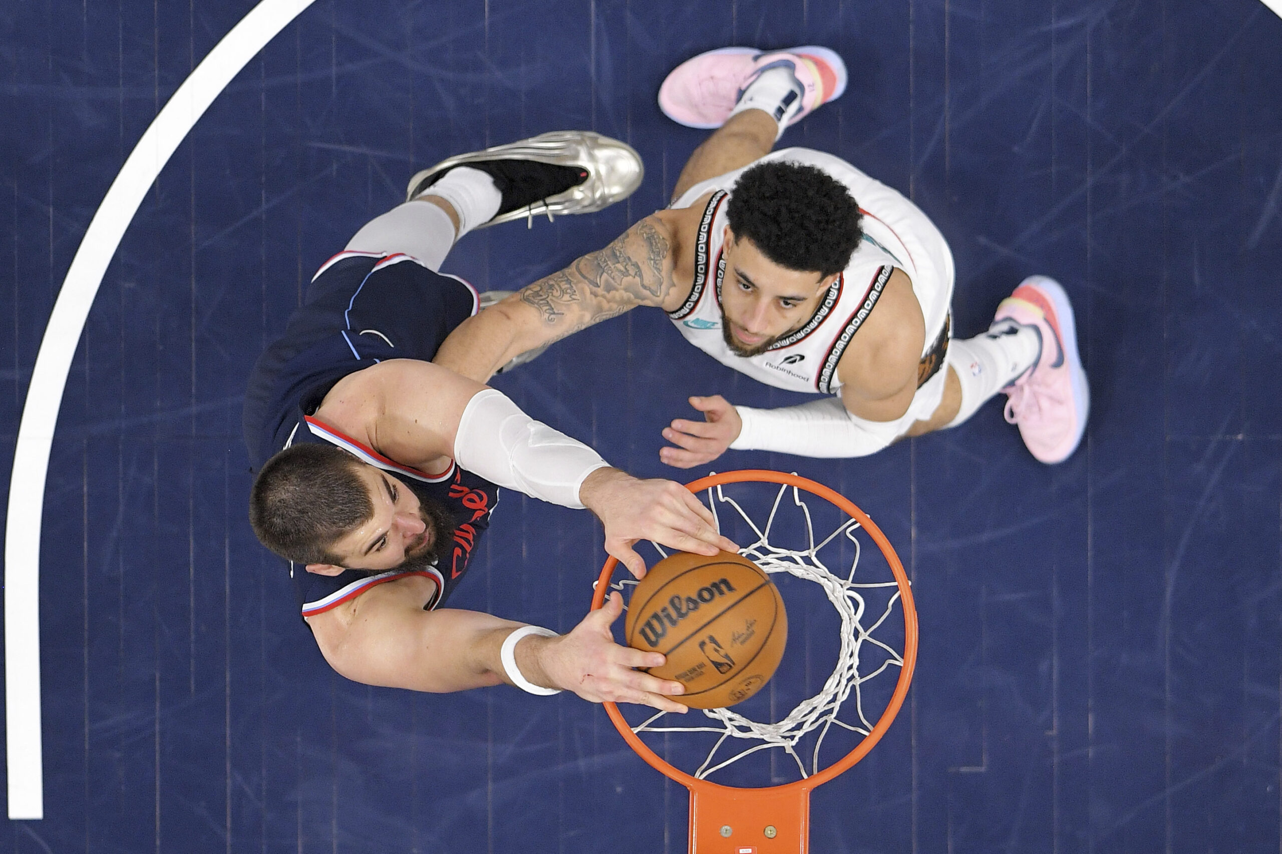 Clippers center Ivica Zubac, left, dunks as Memphis Grizzlies guard...