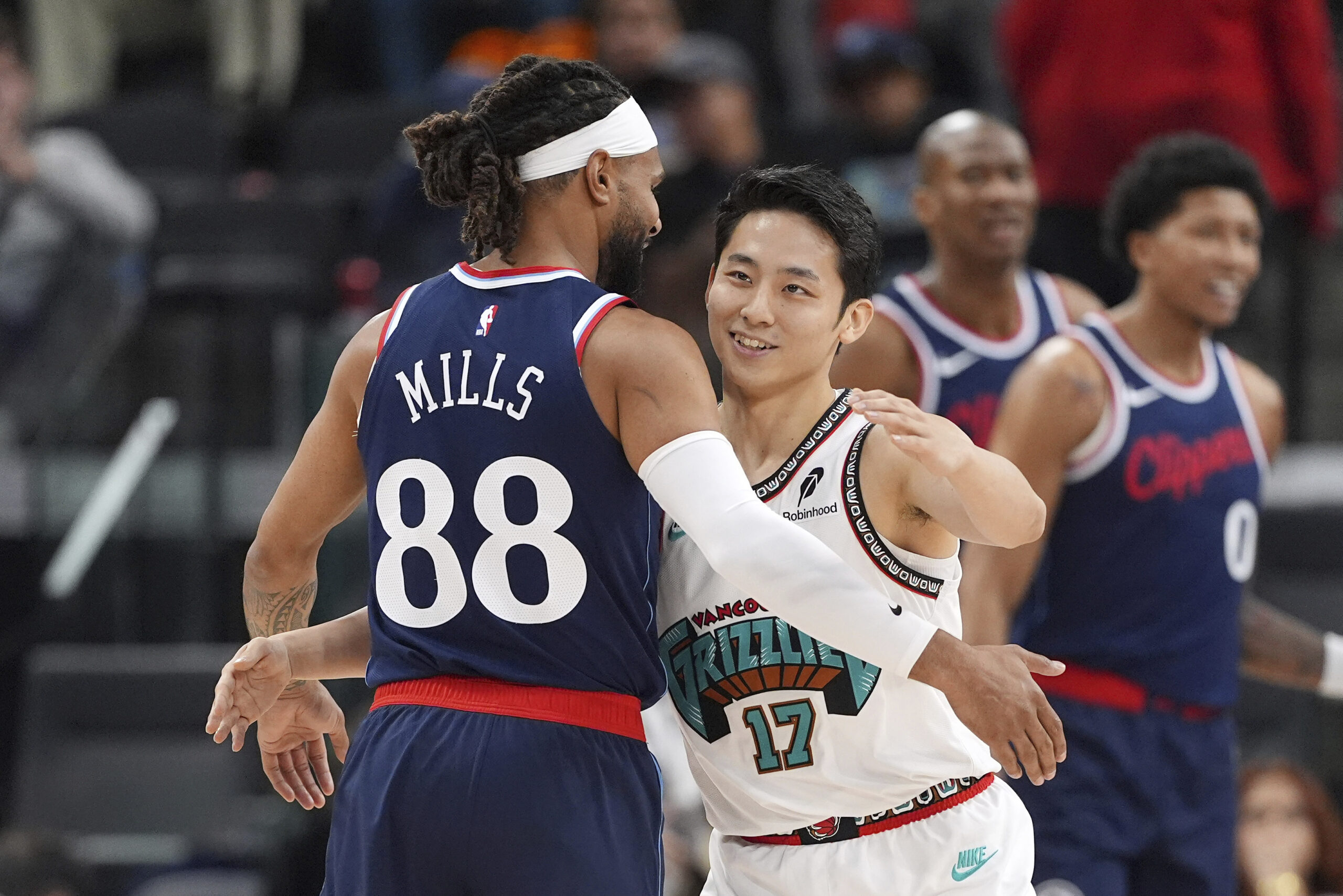 Clippers guard Kris Dunn, left, and Memphis Grizzlies guard Yuki...