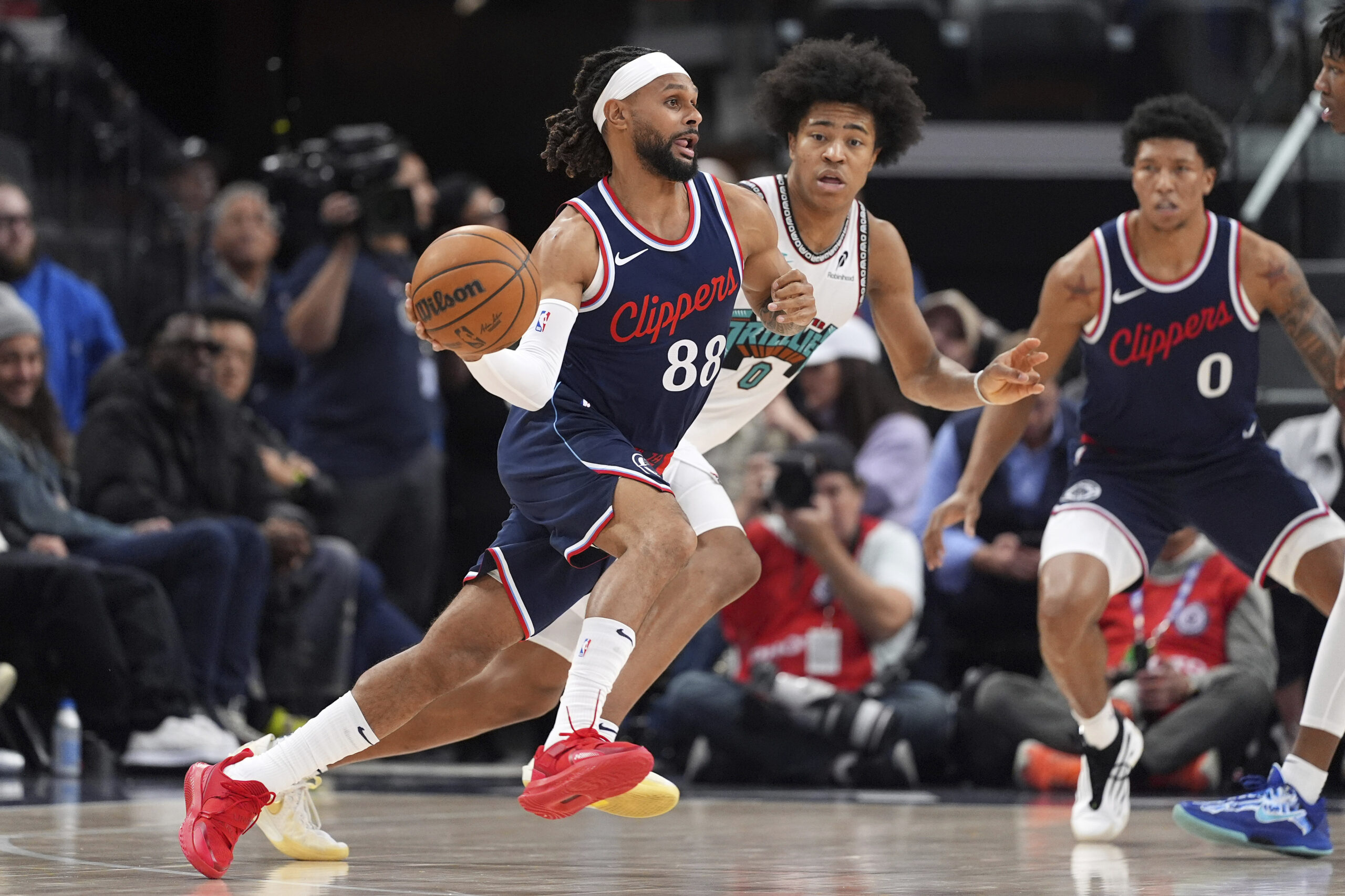 Clippers guard Patty Mills, left, drives by Memphis Grizzlies forward...