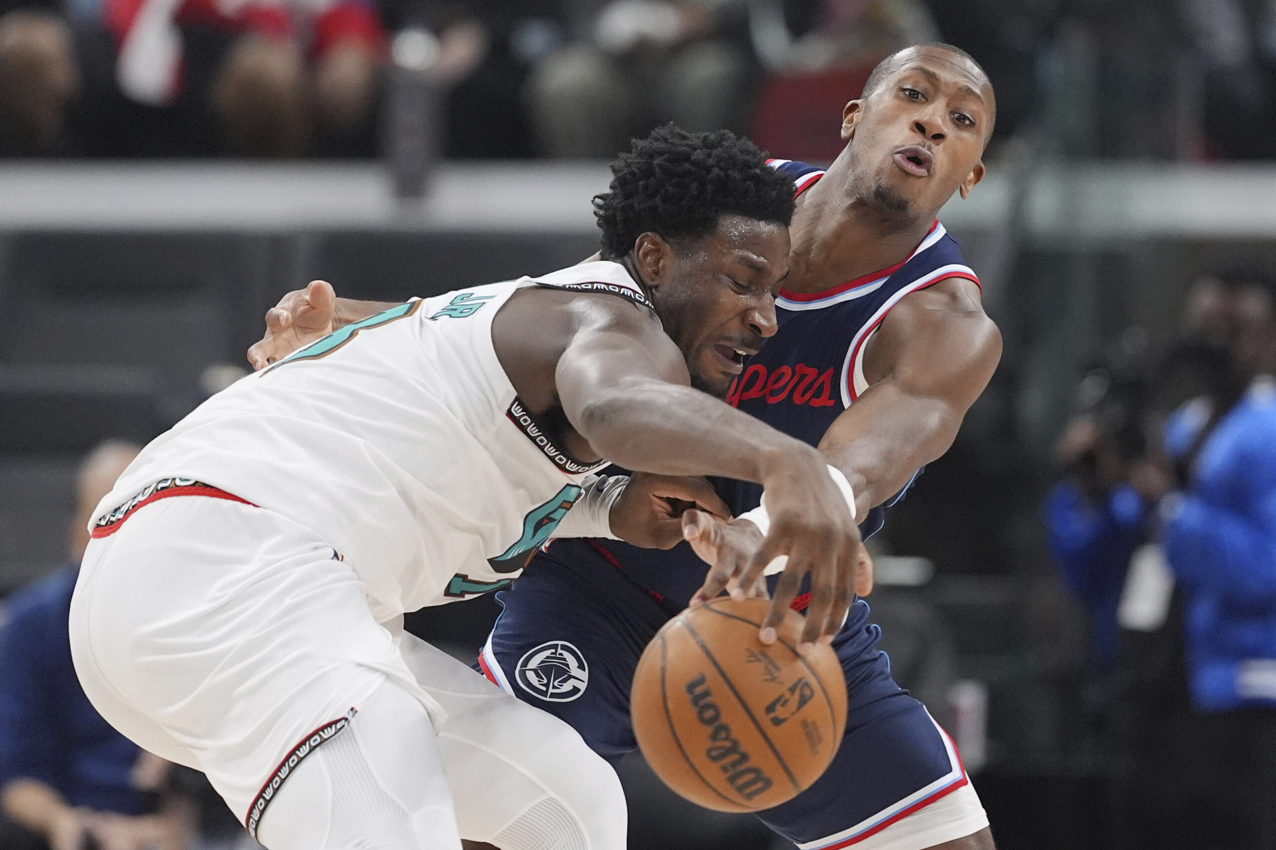 Clippers guard Kris Dunn, right, knocks the ball away from...