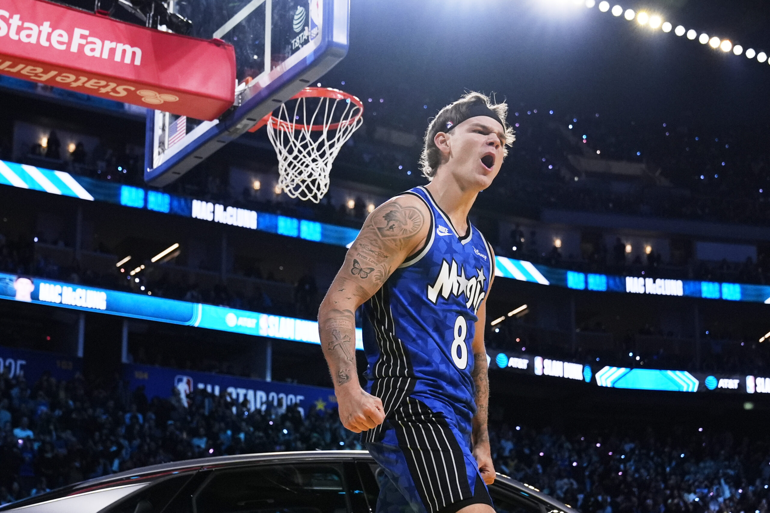 Osceola Magic guard Mac McClung celebrates after dunking over a...