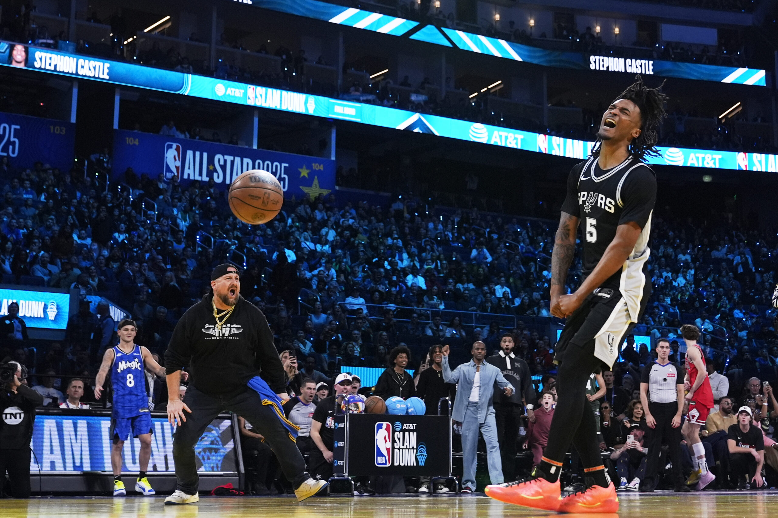 San Antonio Spurs guard Stephon Castle reacts after dunking during...