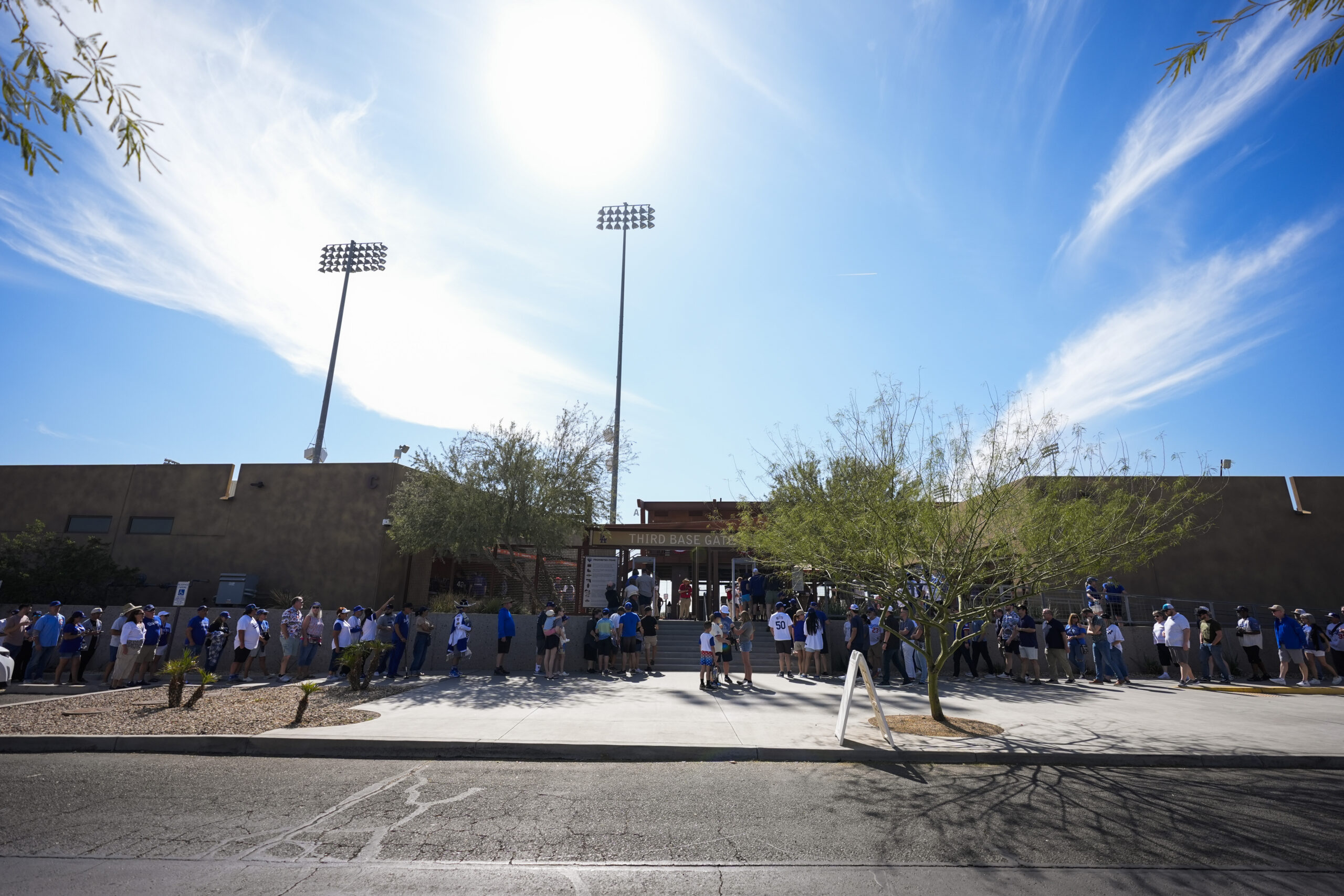 Fans line up before the Cactus League opener between the...