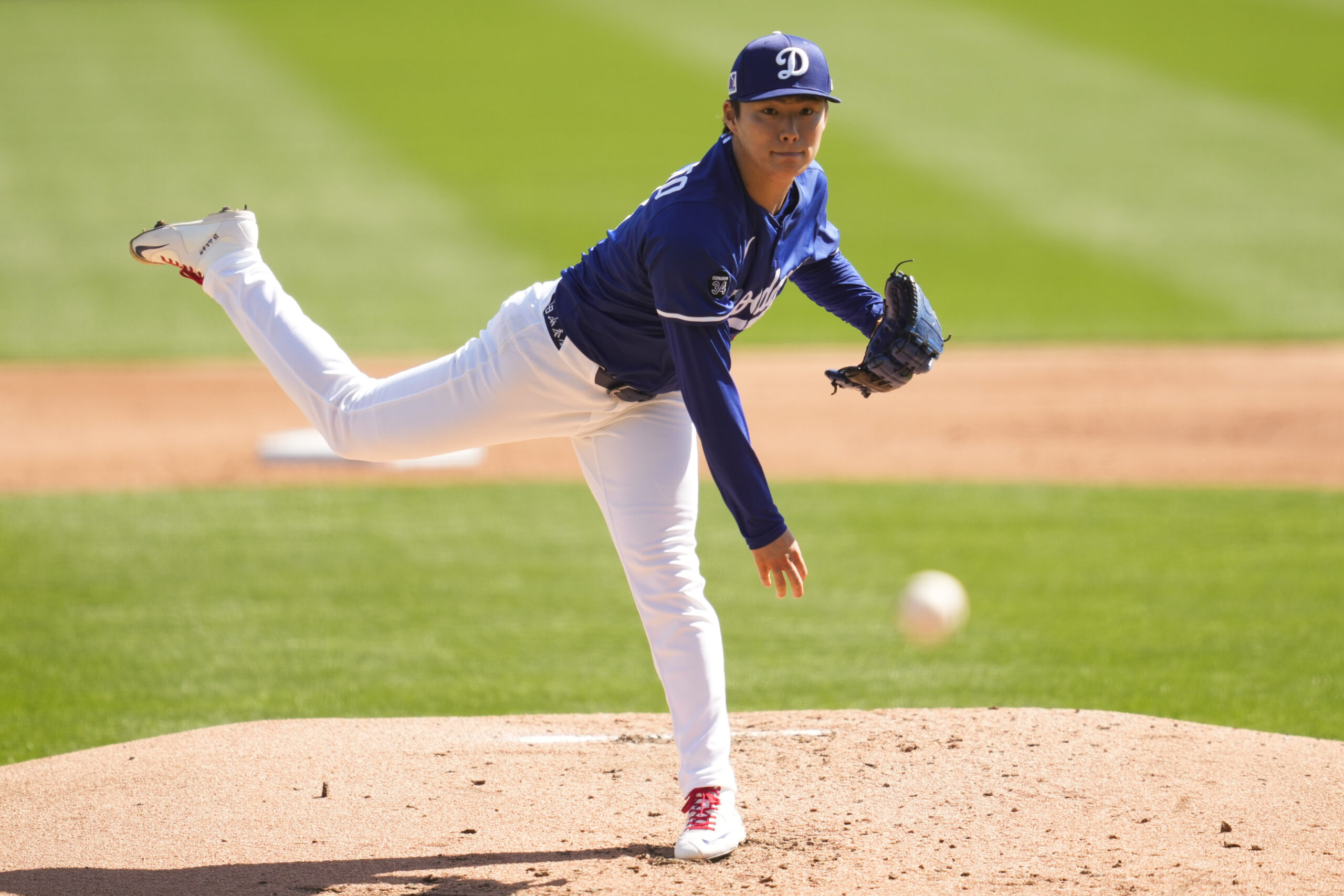 Dodgers starting pitcher Yoshinobu Yamamoto throws during the second inning...