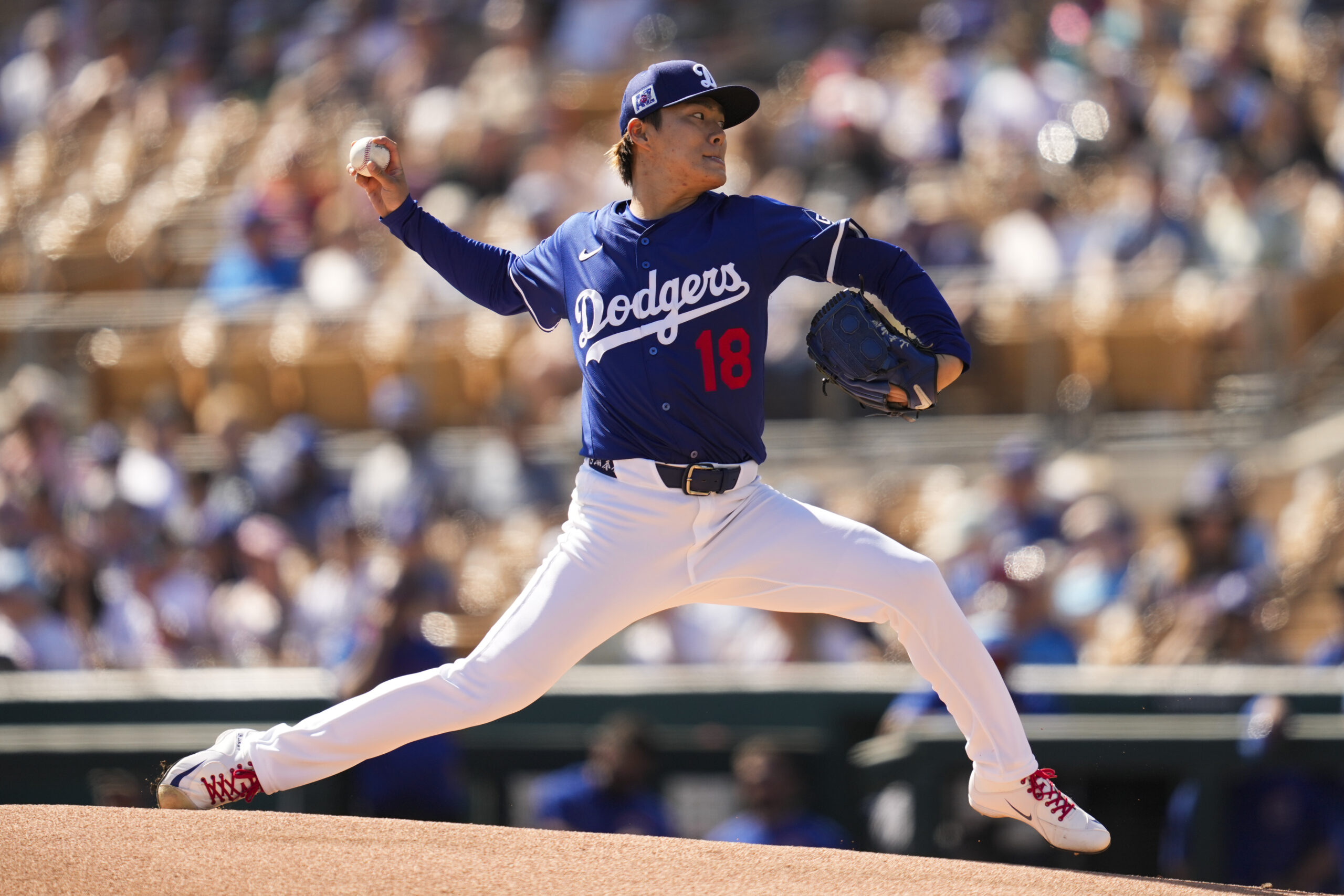 Dodgers starting pitcher Yoshinobu Yamamoto throws during the first inning...