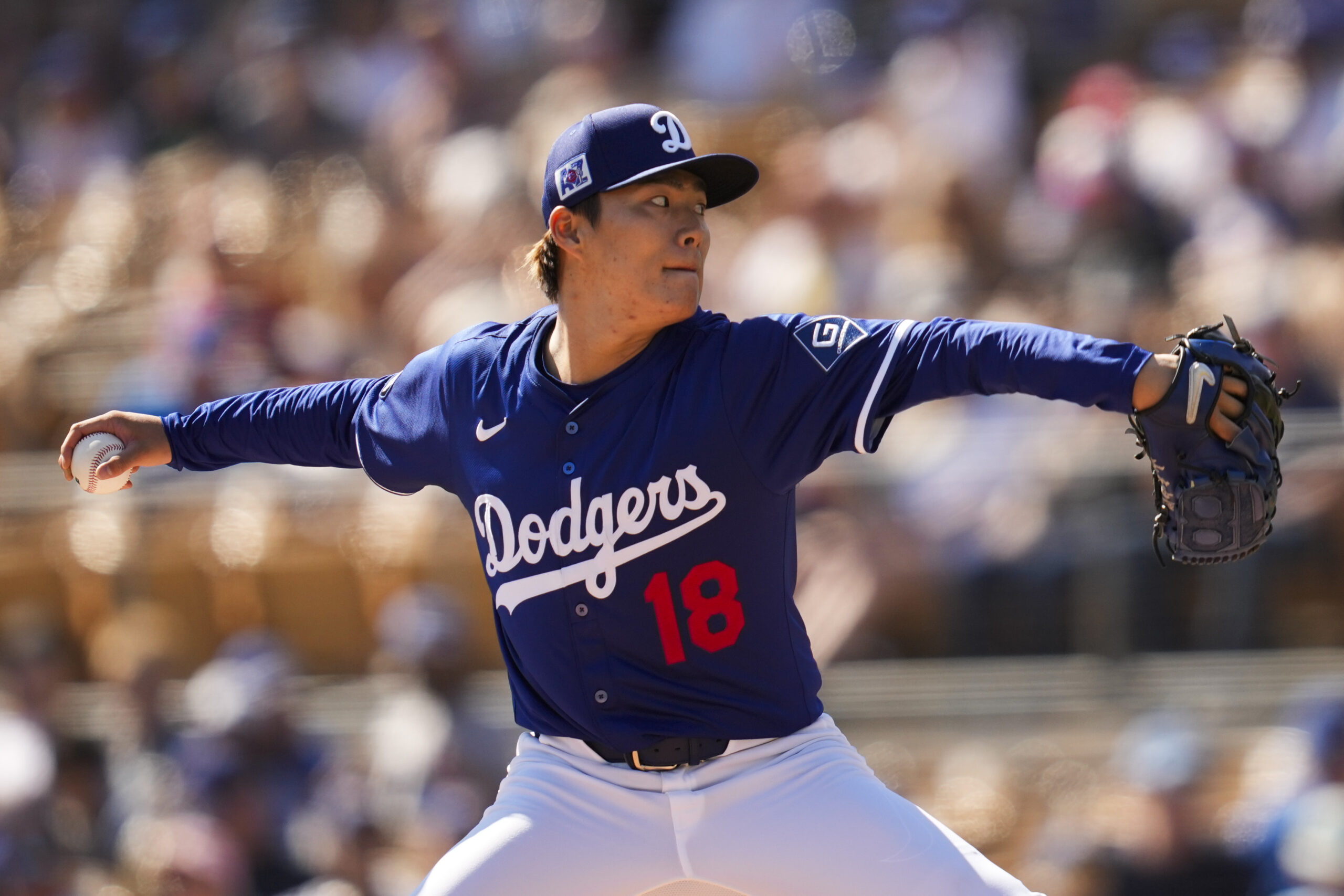 Dodgers starting pitcher Yoshinobu Yamamoto throws during the first inning...