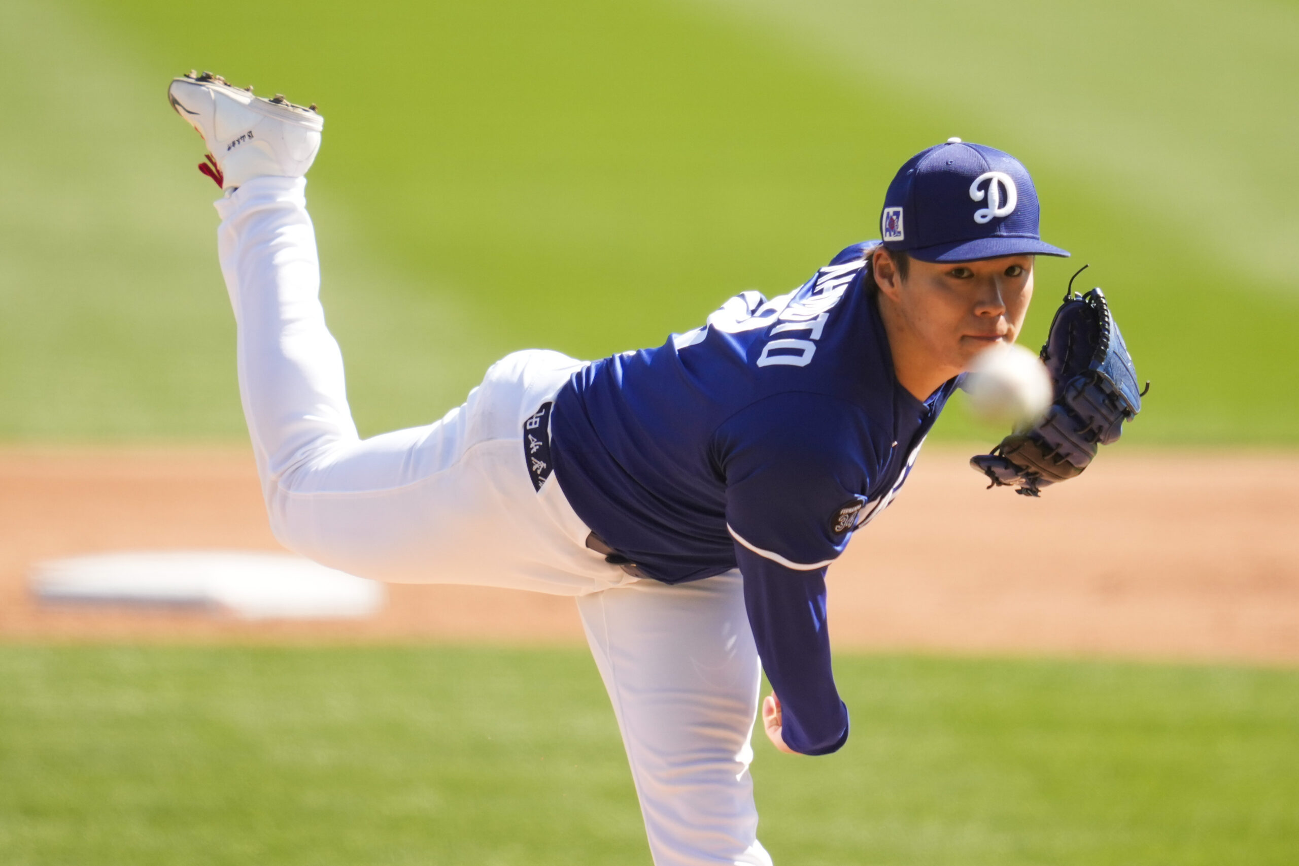 Dodgers starting pitcher Yoshinobu Yamamoto throws during the second inning...