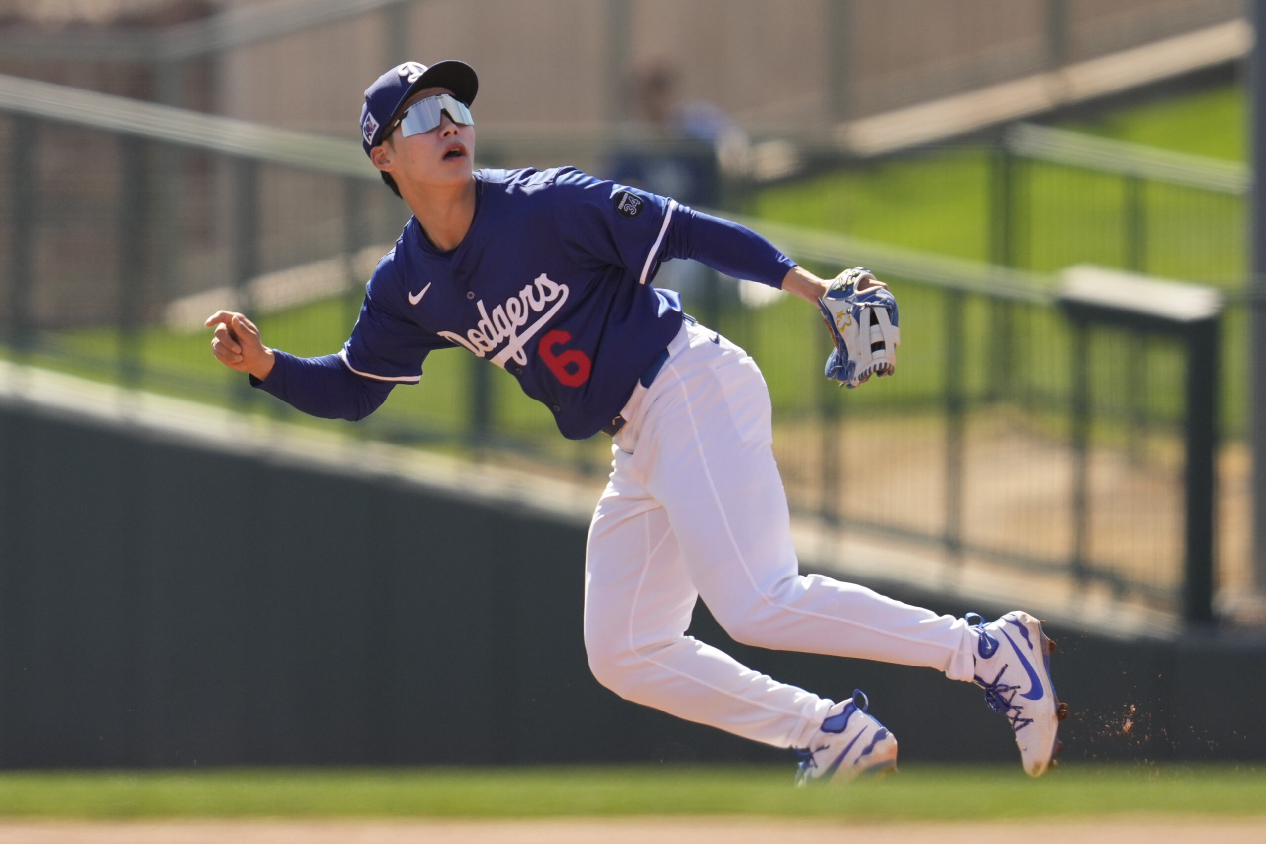 Dodgers second baseman Hyeseong Kim runs to catch a fly...