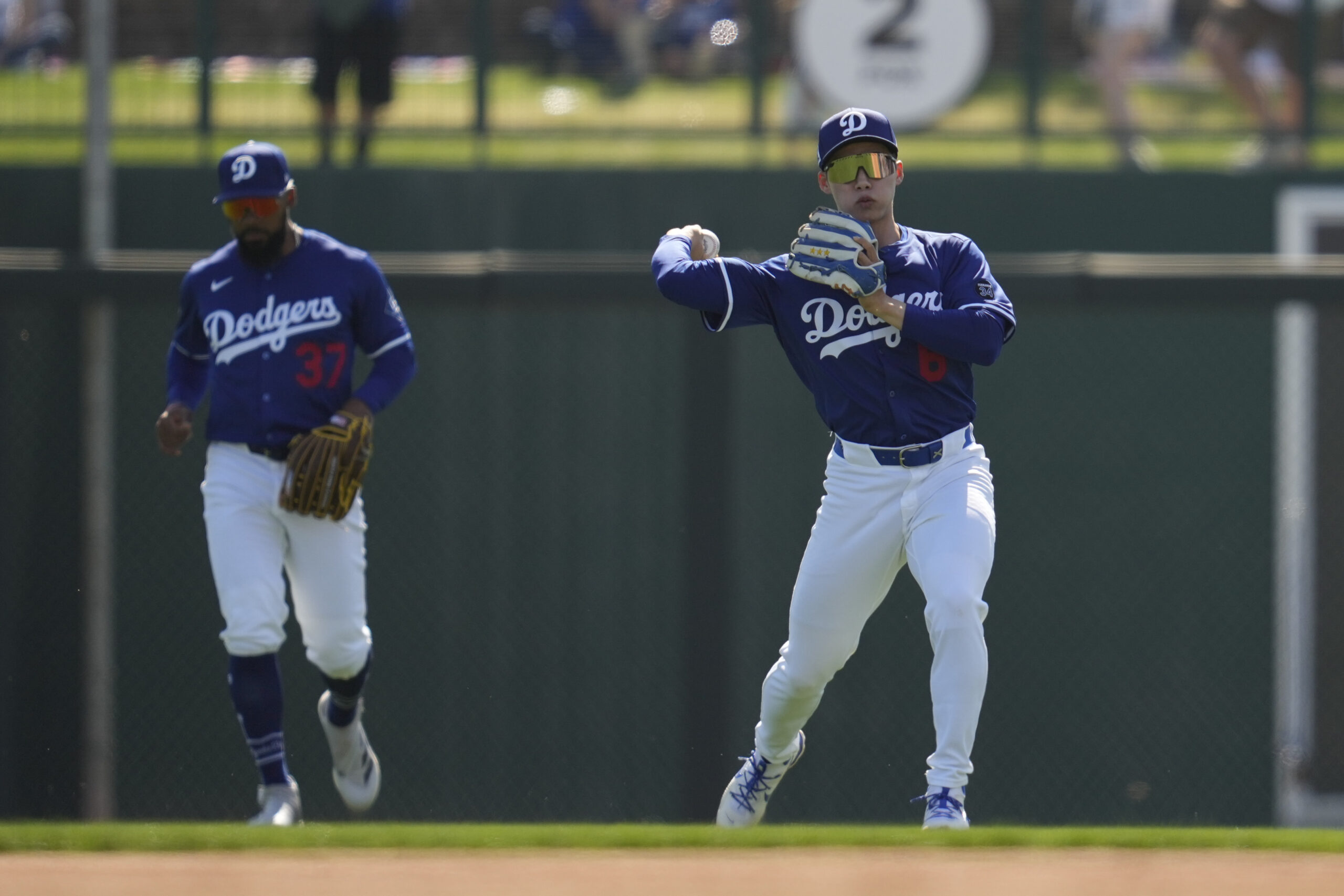 Dodgers second baseman Hyeseong Kim throws in a fly ball...