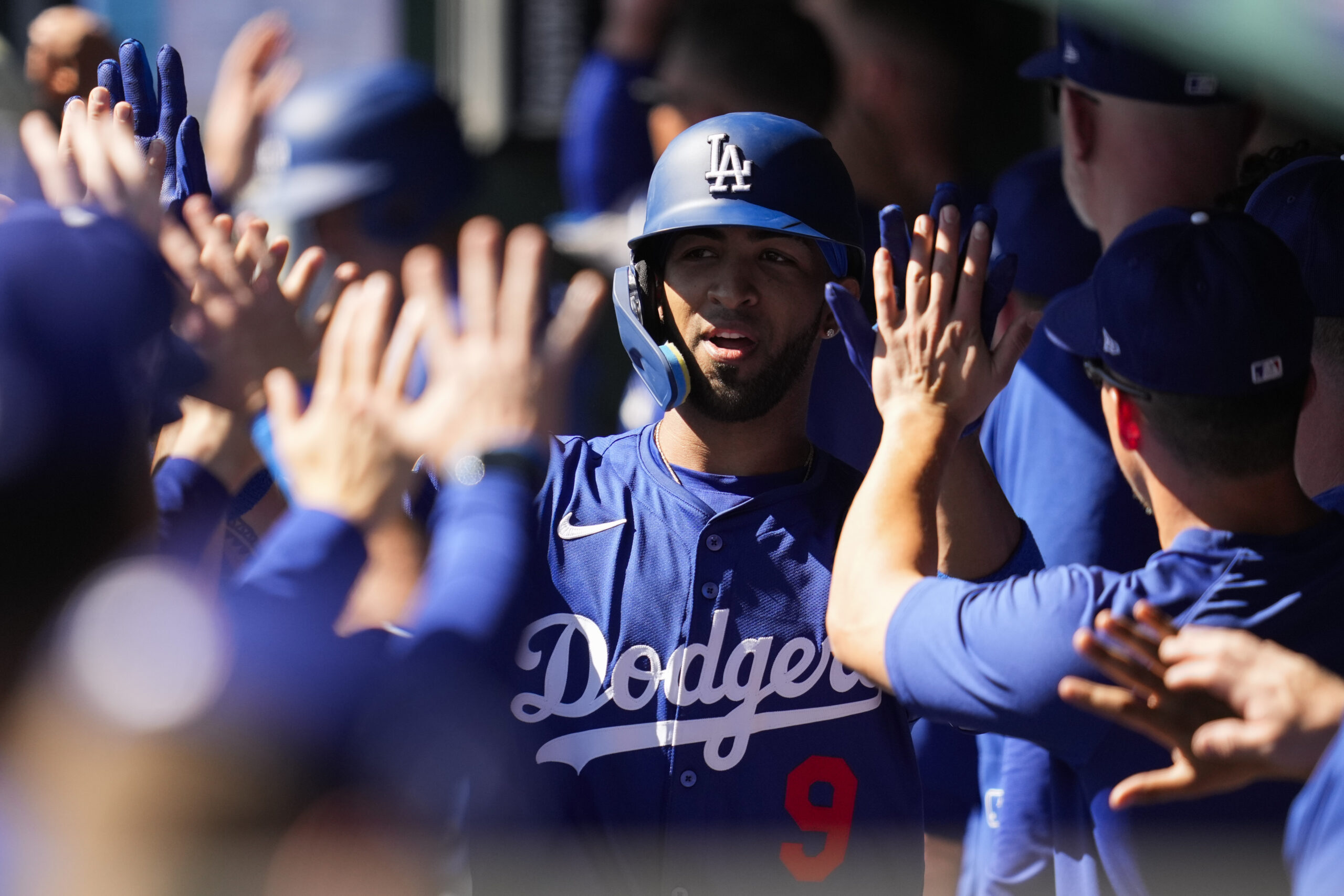 The Dodgers’ Eddie Rosario celebrates in the dugout after hitting...