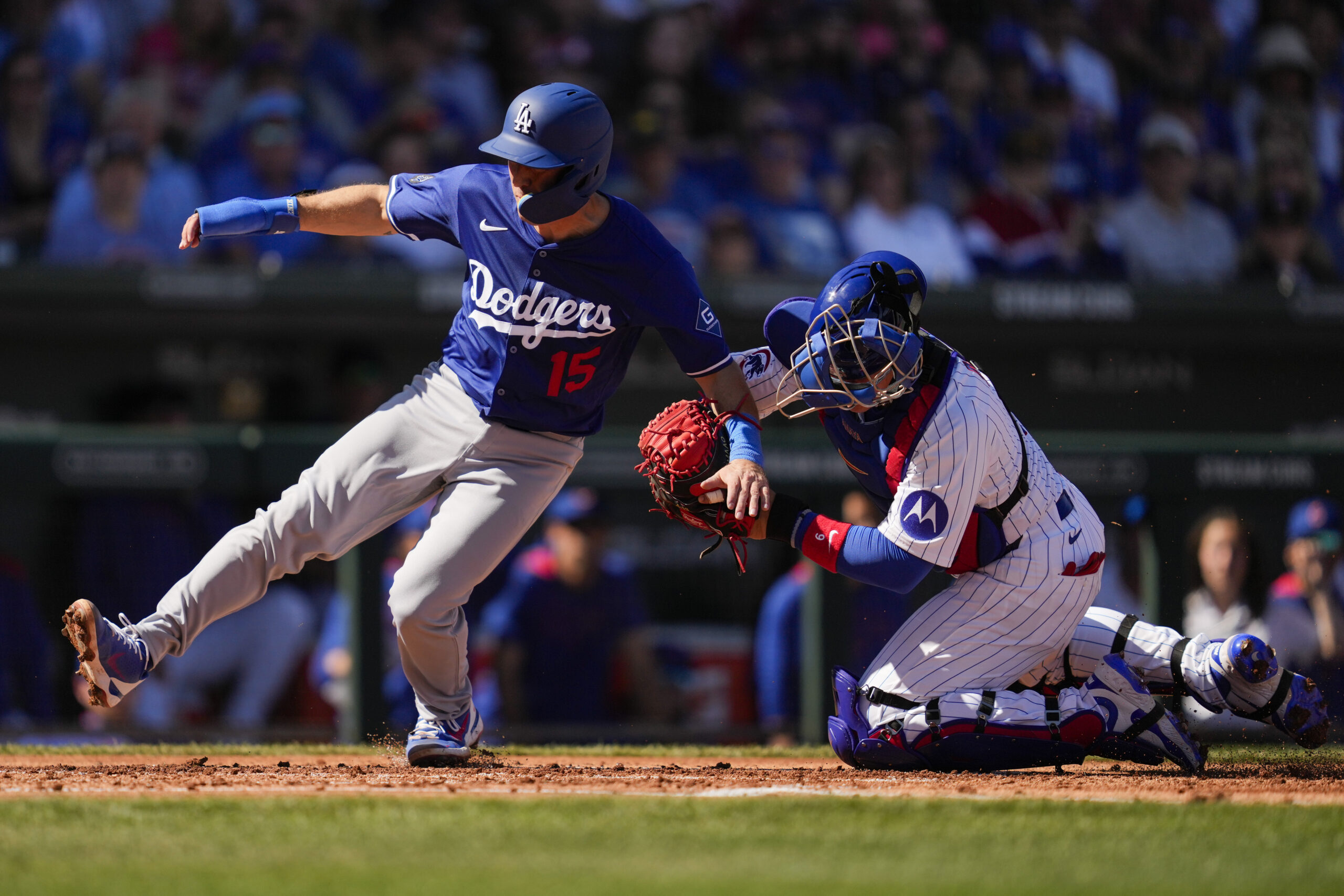 The Dodgers’ Austin Barnes, left, is tagged out at home...