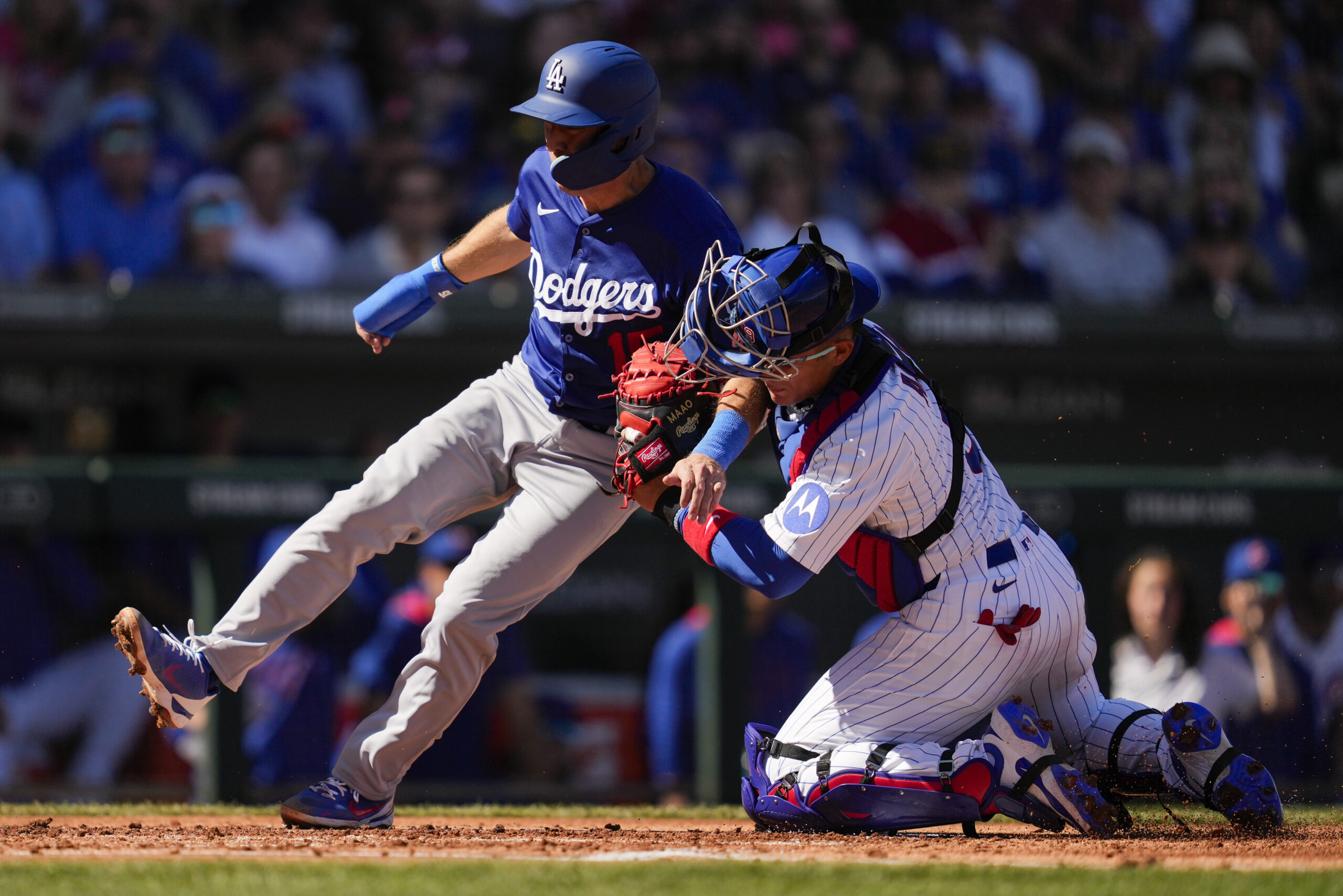 The Dodgers’ Austin Barnes, left, is tagged out at home...