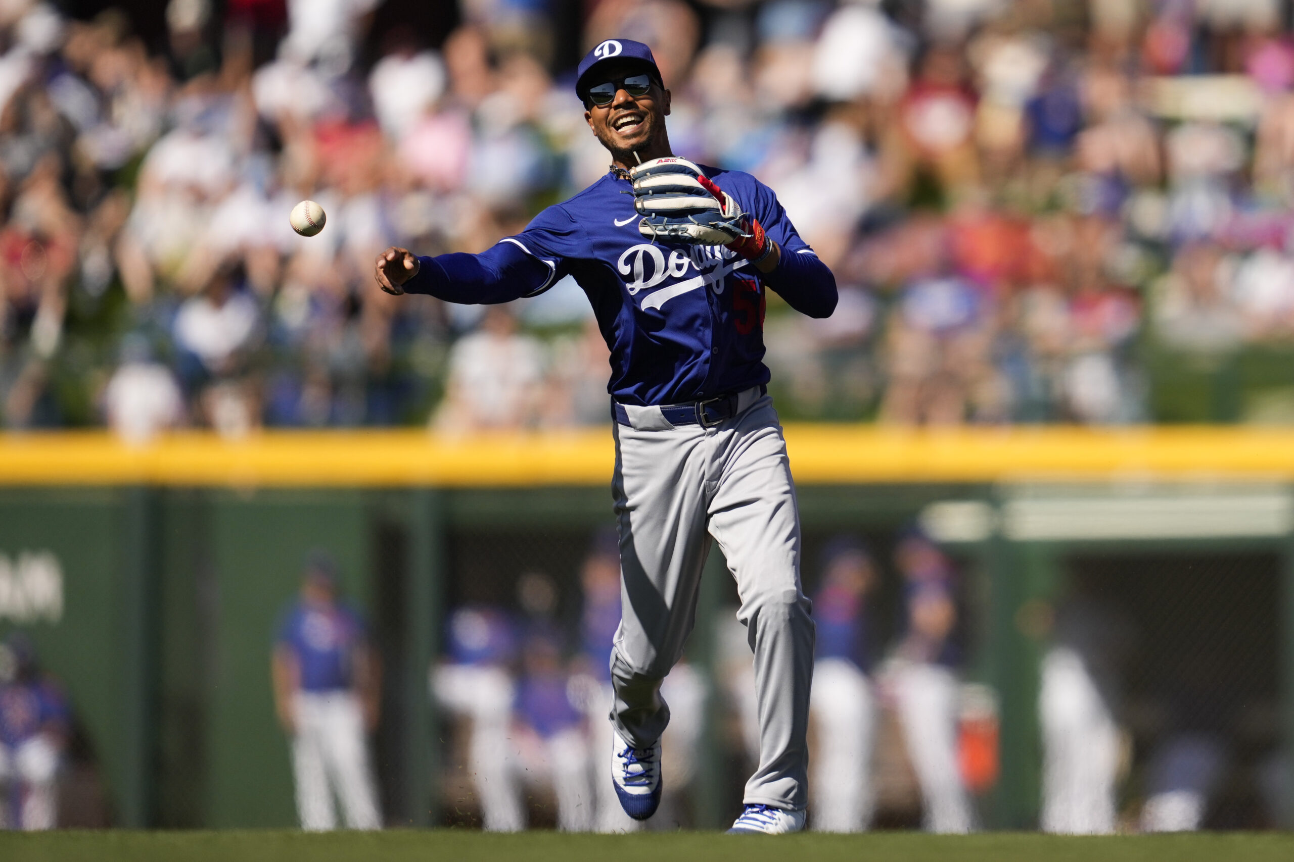 Dodgers shortstop Mookie Betts throws to first to out Chicago...