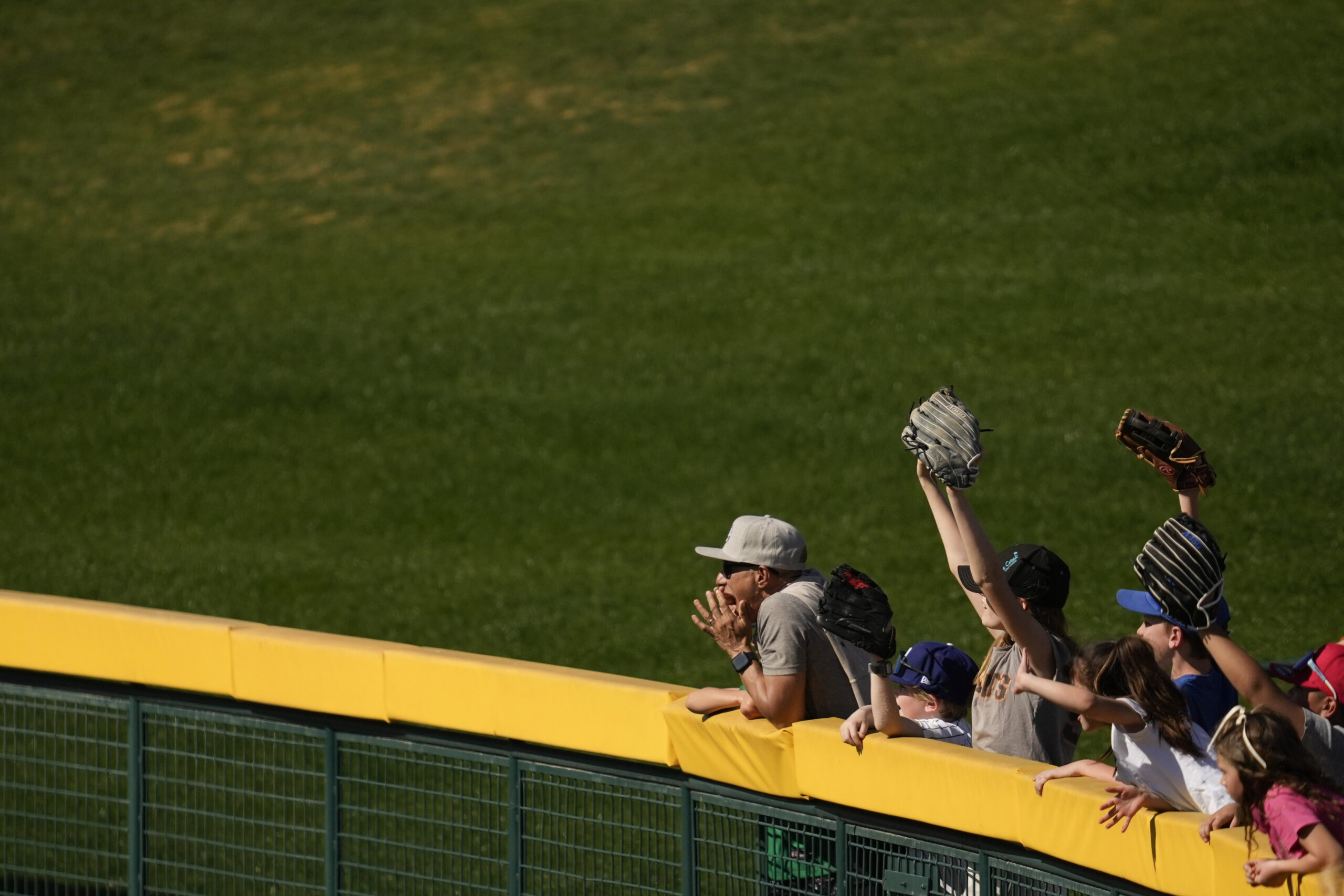 Fans yell to players during the fourth inning of a...