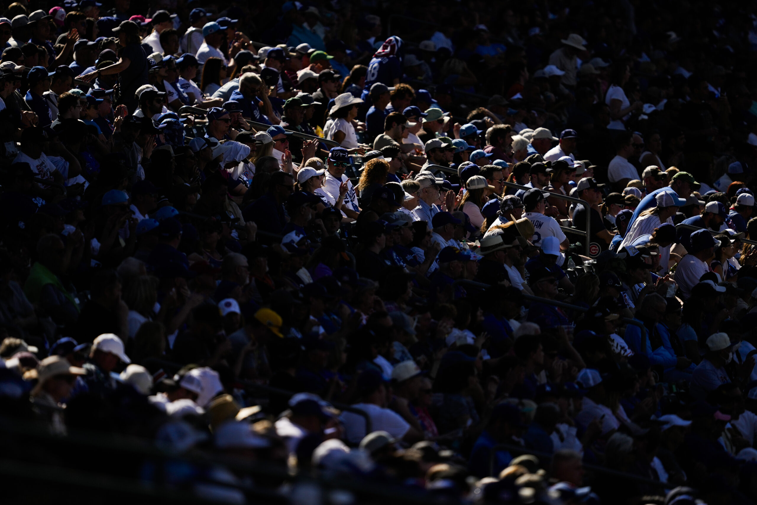 Fans sit in the stands during the fourth inning of...