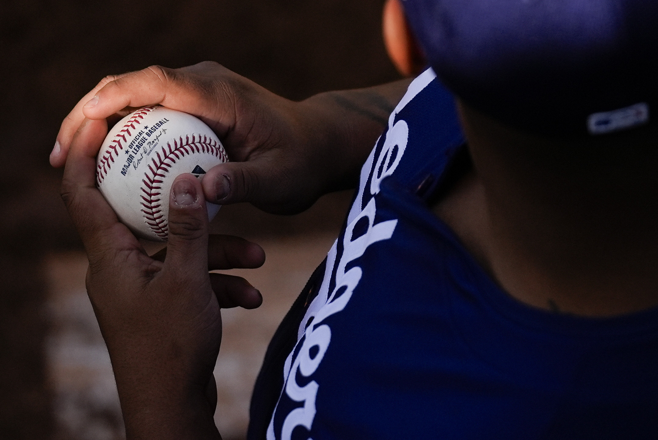 Dodgers catcher Griffin Lockwood-Powell holds a baseball in the bullpen...