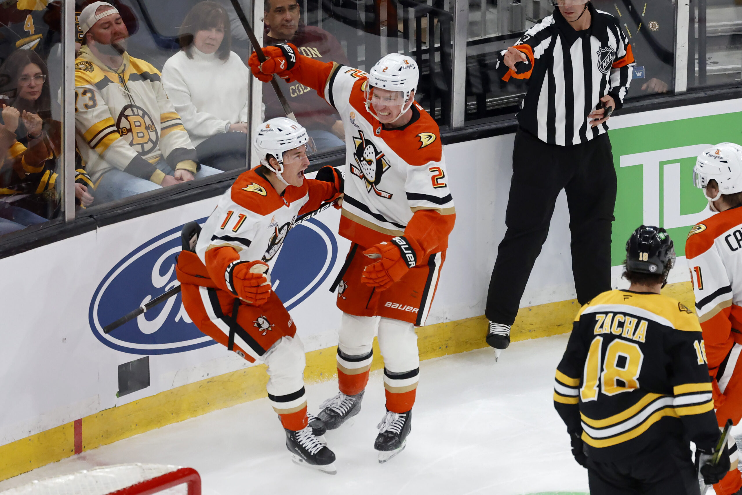 Ducks center Trevor Zegras (11) celebrates with teammate Jackson LaCombe...