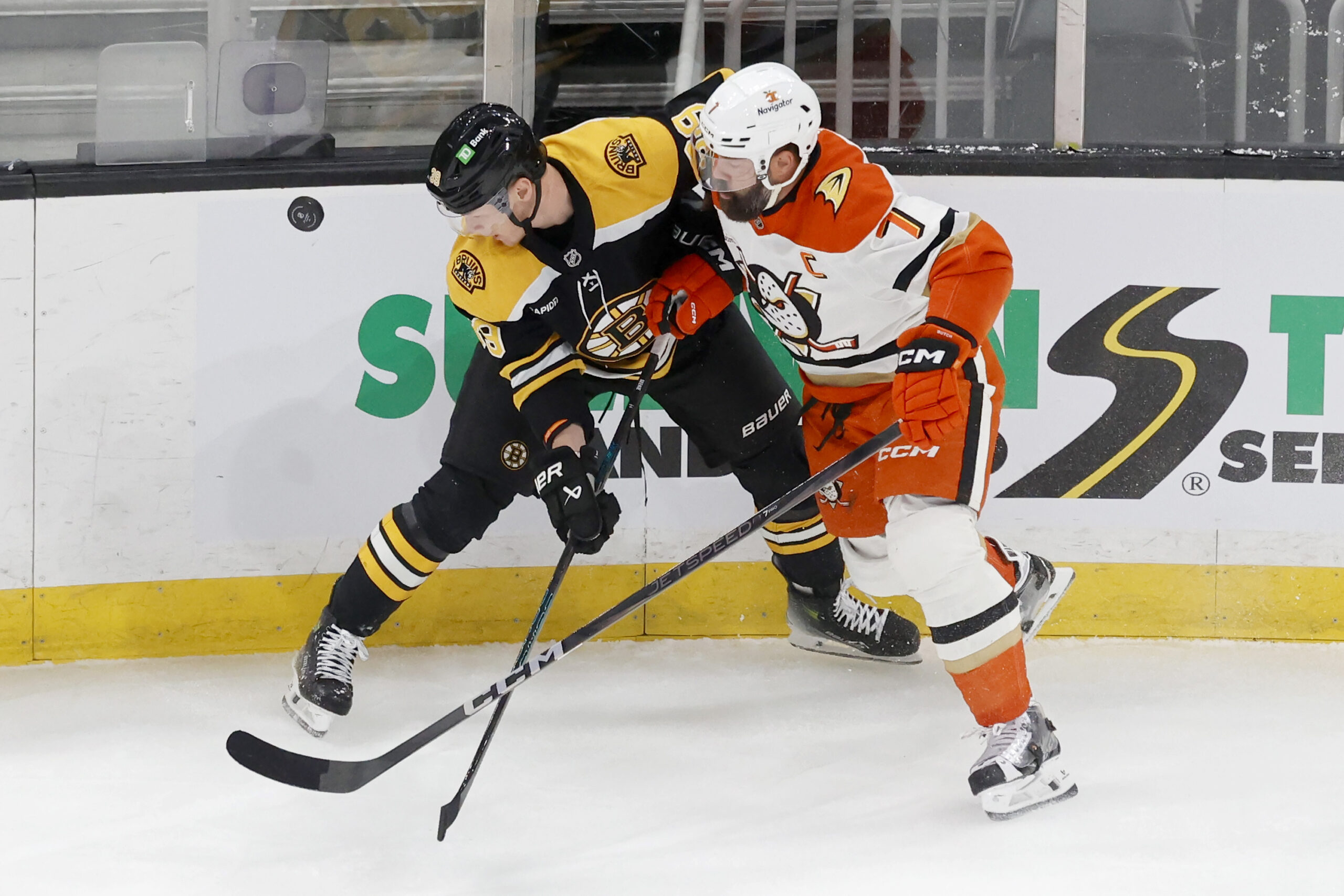 Boston Bruins center Morgan Geekie, left, and Ducks defenseman Radko...