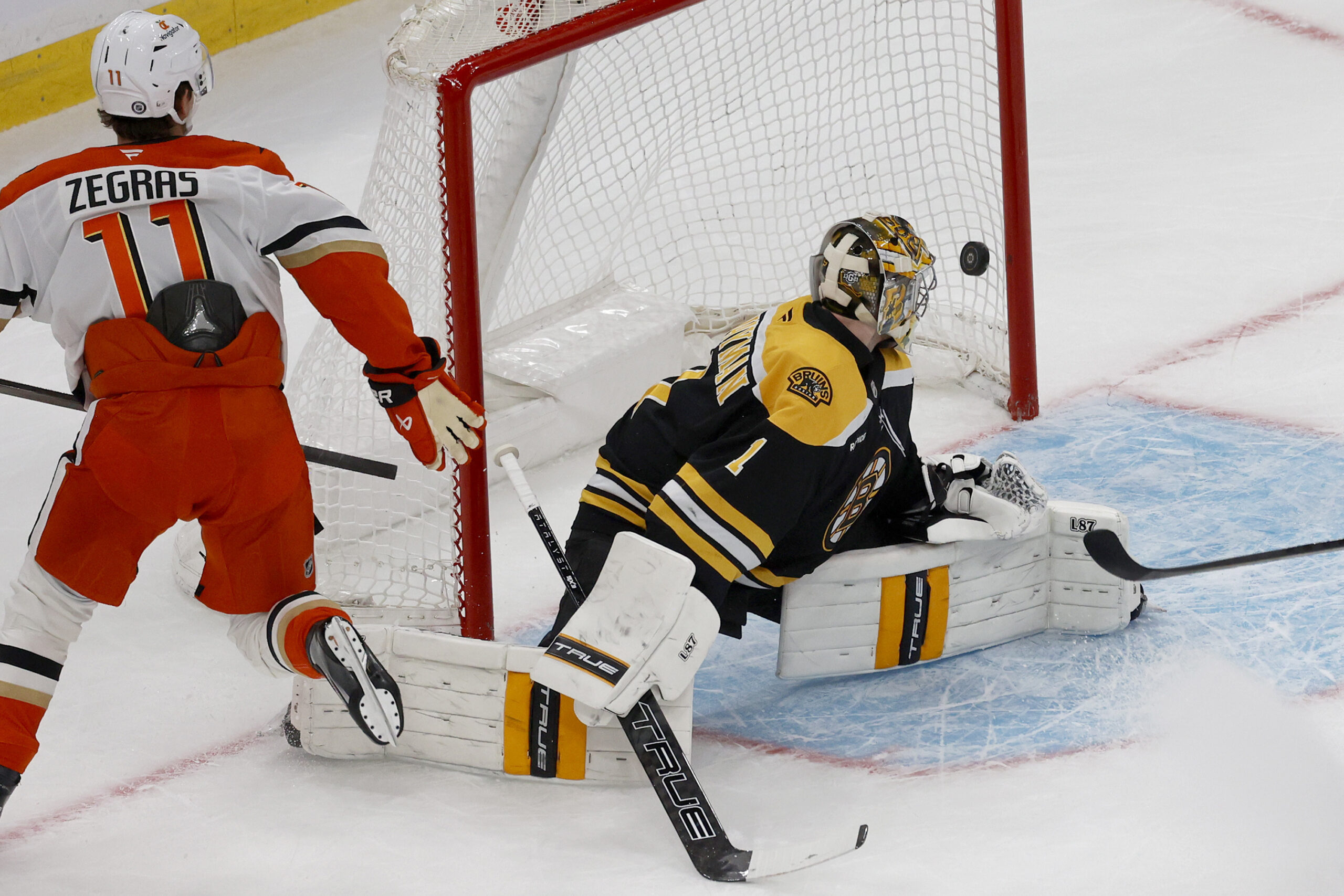 Ducks center Trevor Zegras (11) scores past Boston Bruins goaltender...