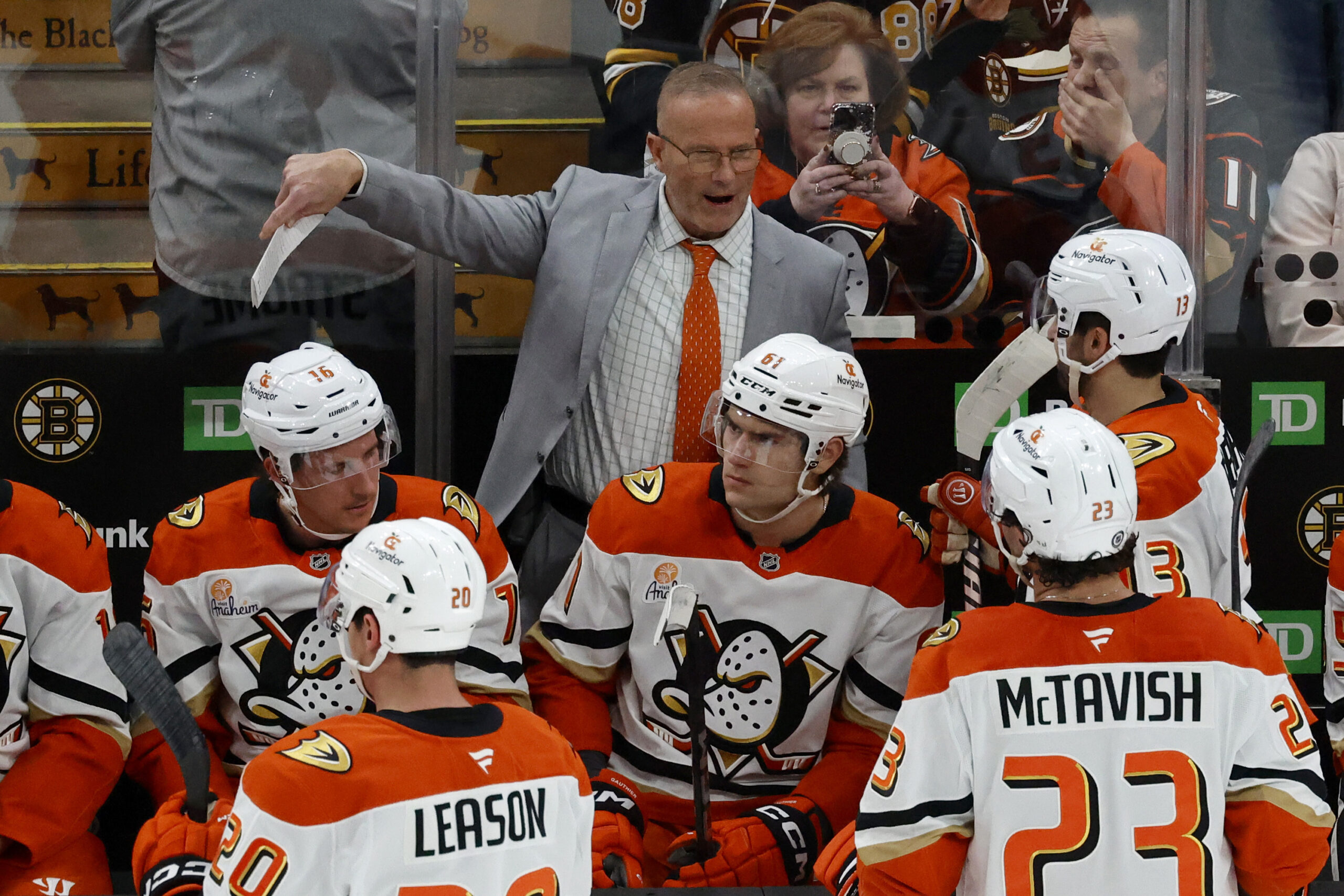 Ducks head coach Greg Cronin, center top, talks to his...