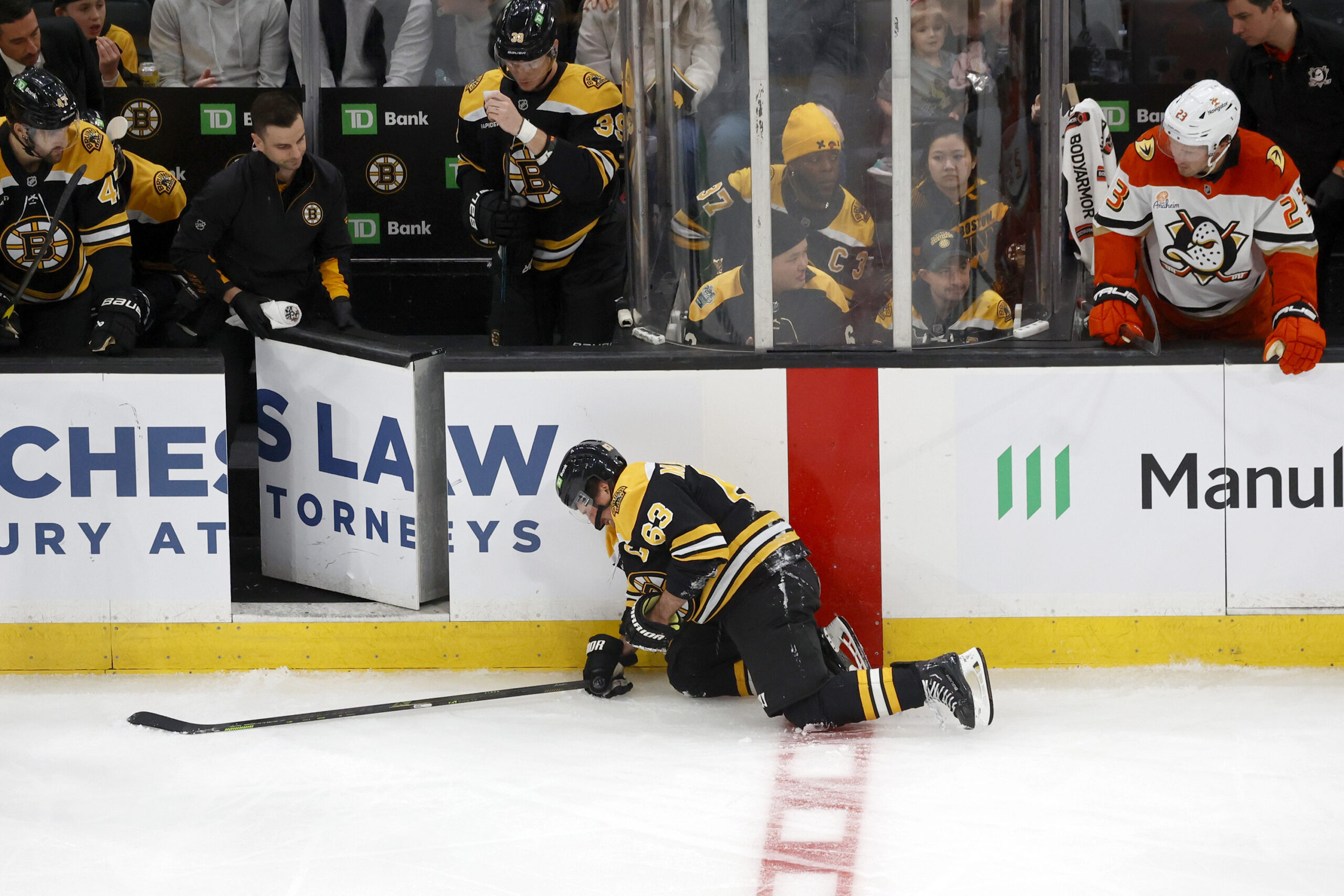 Boston Bruins left wing Brad Marchand (63) crawls to the...