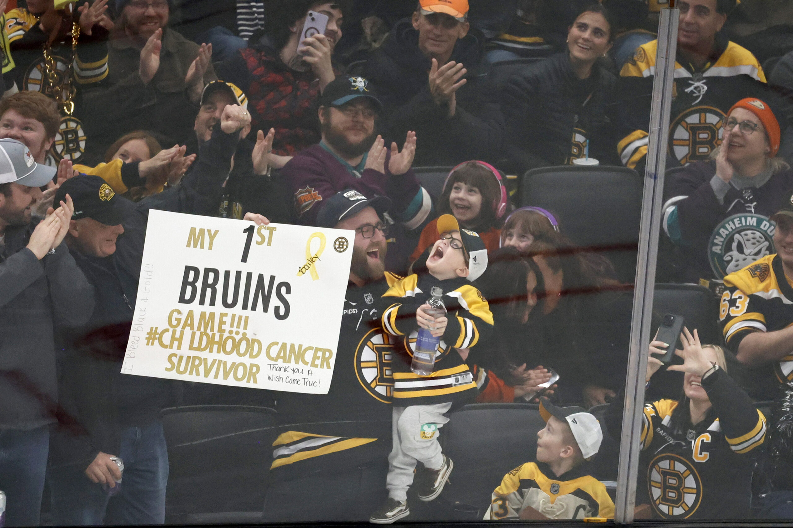 Fans cheer for a young fan during the second period...