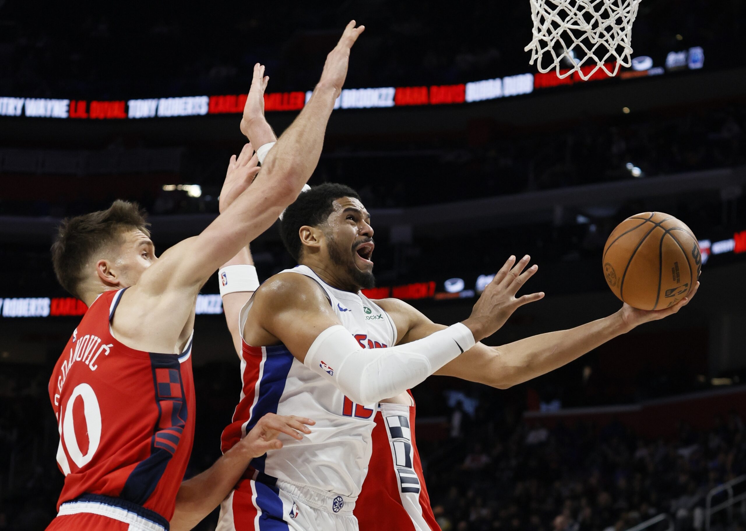 Detroit Pistons forward Tobias Harris, right, goes to the basket...