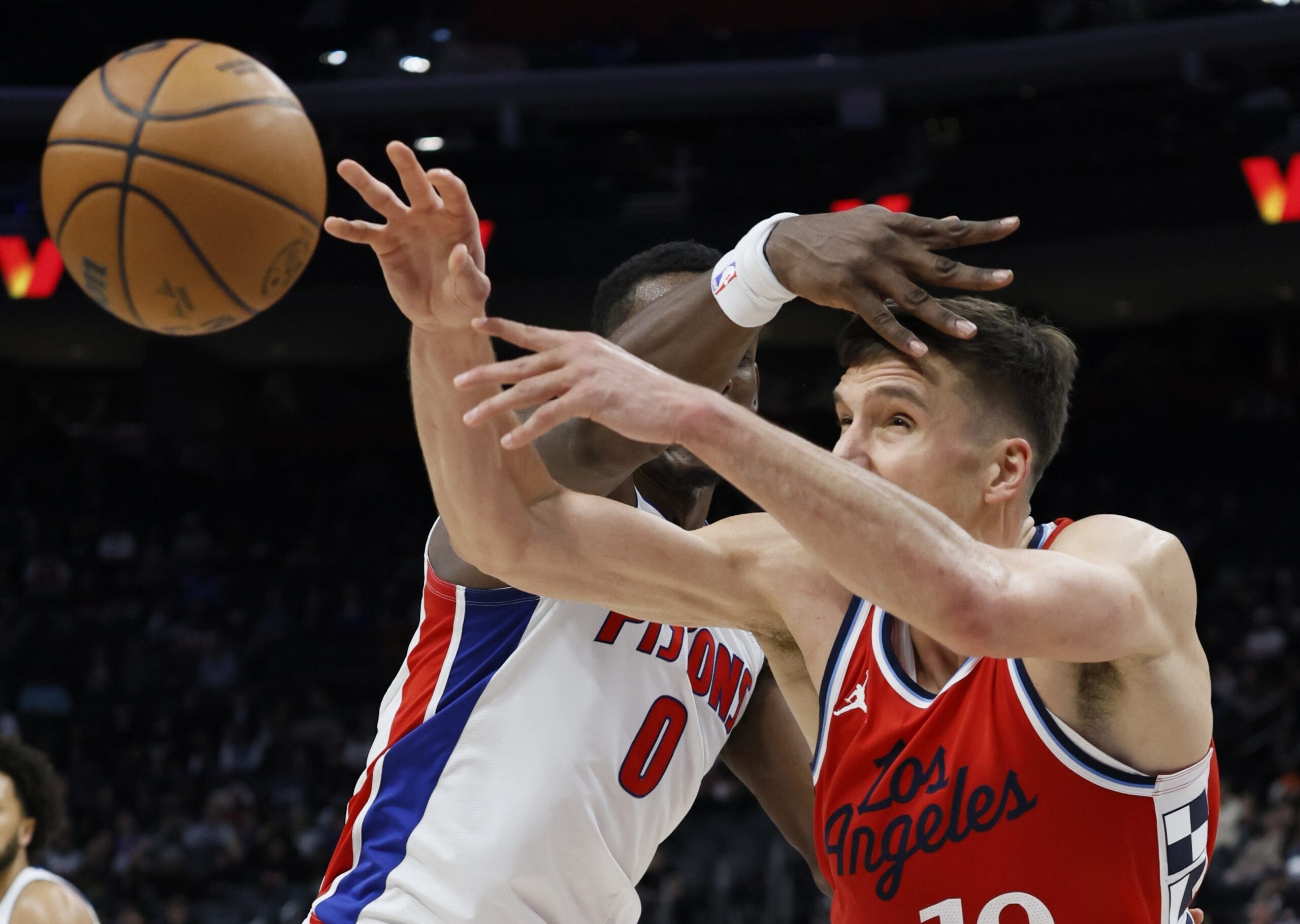 Clippers guard Bogdan Bogdanovic, right, passes the ball against Detroit...