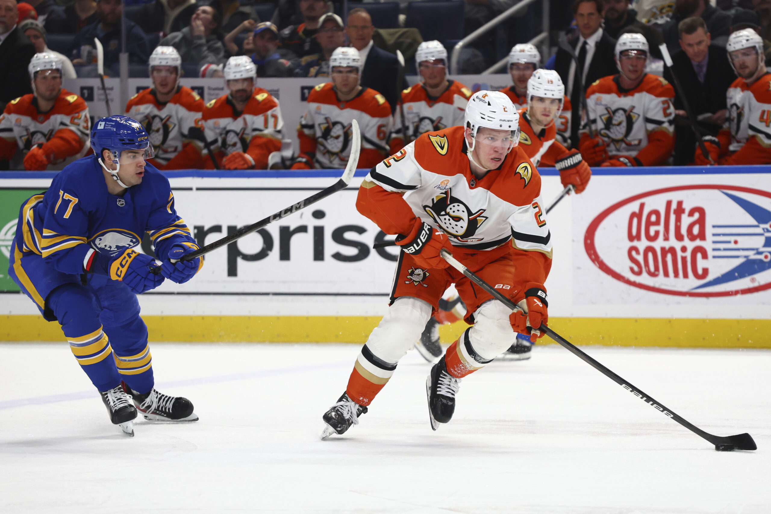 Ducks defenseman Jackson LaCombe is chased by Buffalo Sabres right...