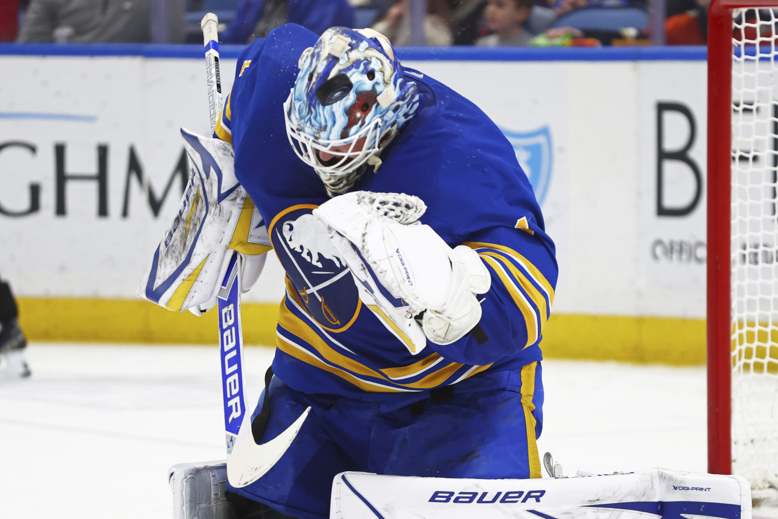 Buffalo Sabres goaltender Ukko-Pekka Luukkonen uses his mask to deflect...