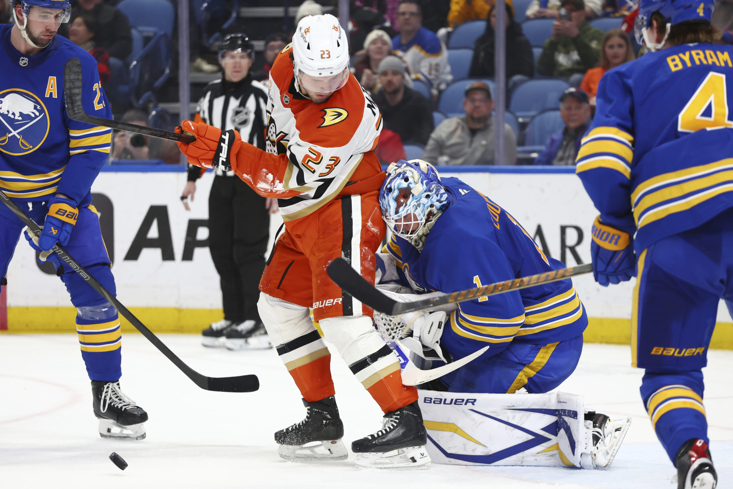 Ducks center Mason McTavish (23) is stopped by Buffalo Sabres...