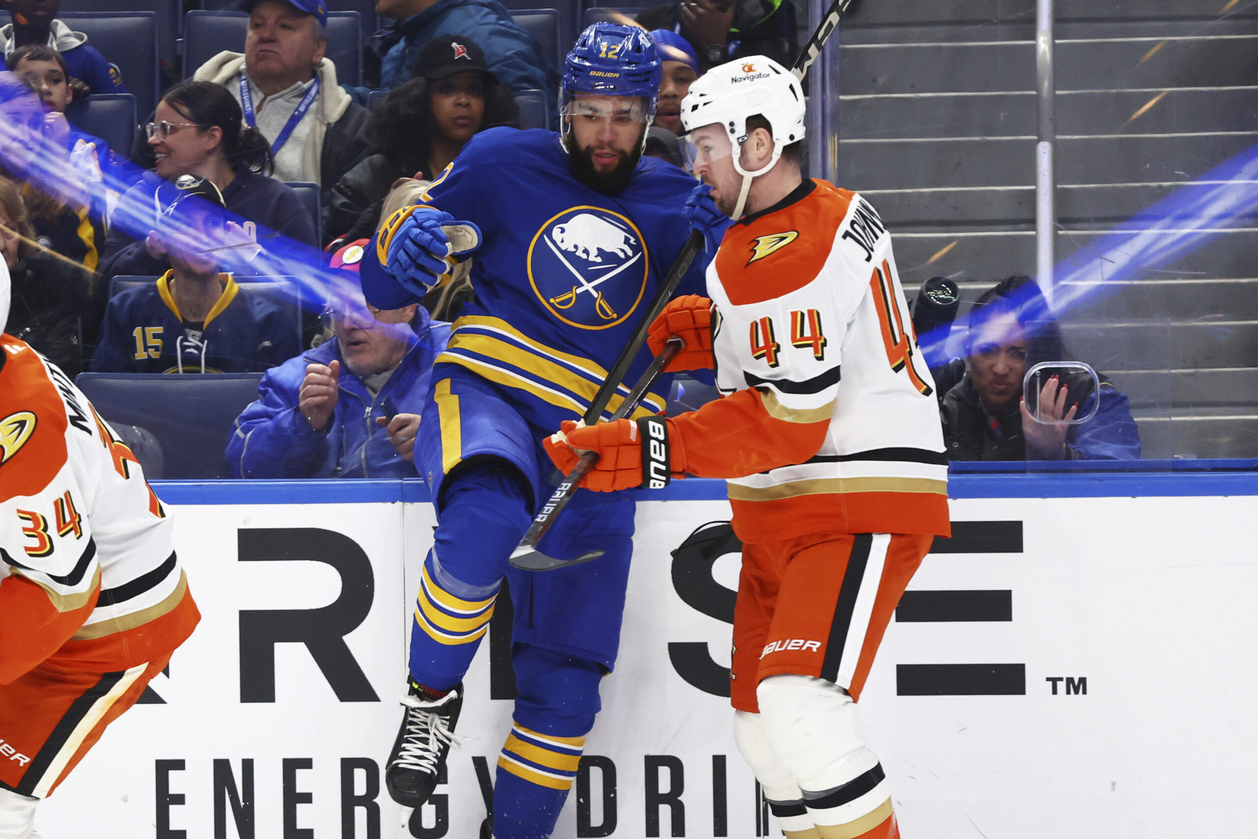 Ducks left wing Ross Johnston (44) checks Buffalo Sabres left...