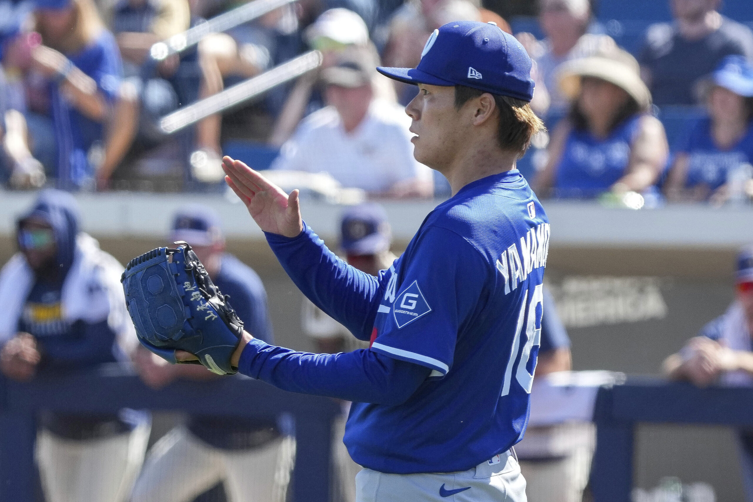 Dodgers pitcher Yoshinobu Yamamoto claps after the last out in...