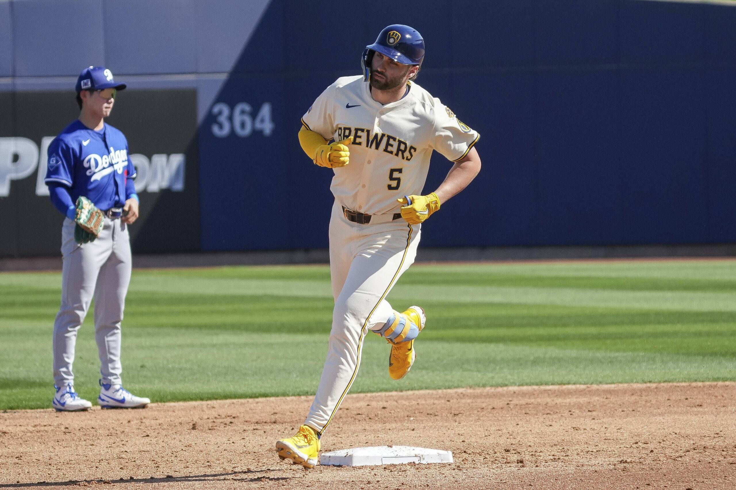 The Milwaukee Brewers’ Garrett Mitchell (5) rounds second base after...