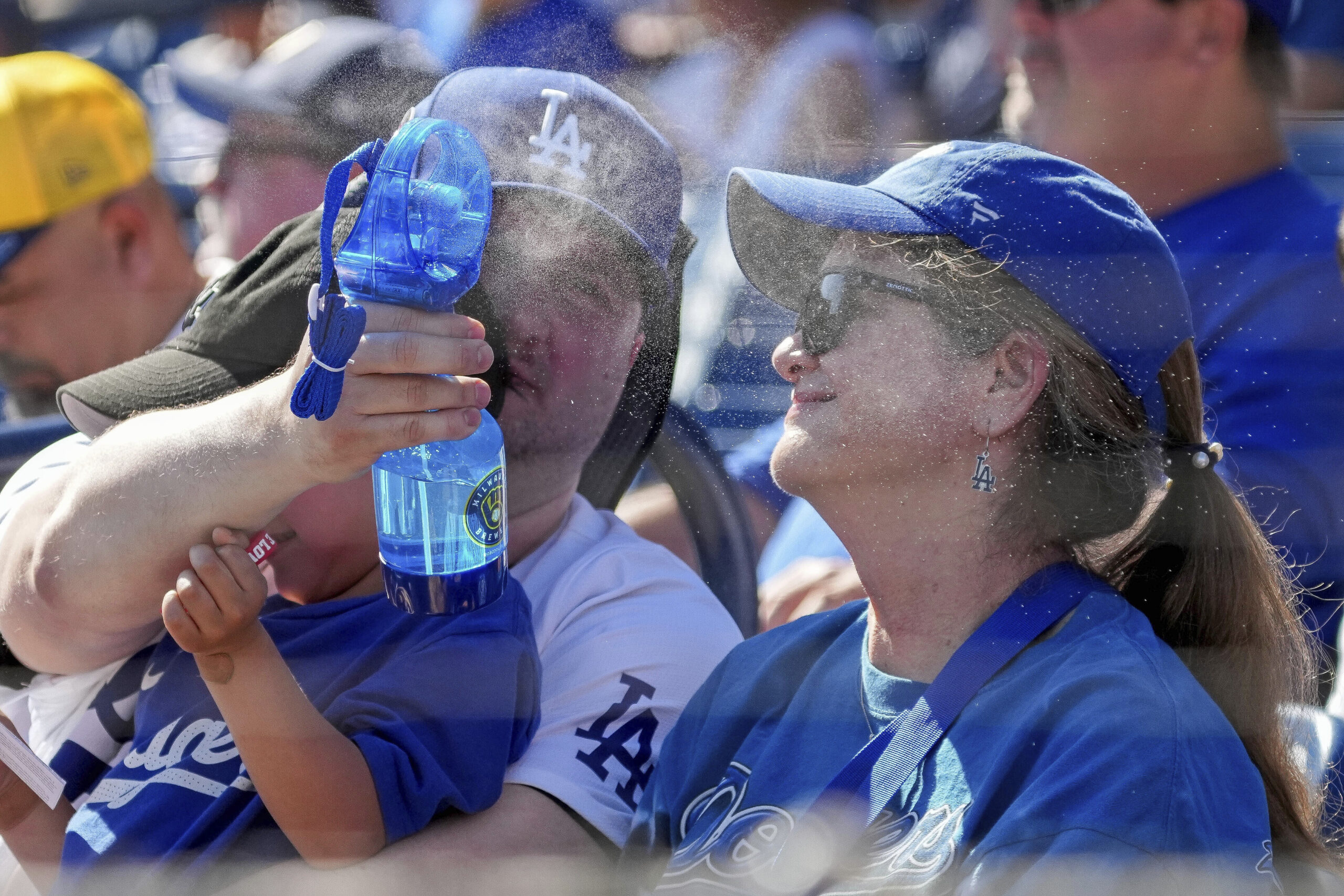 A fan gets cooled off during the second inning of...