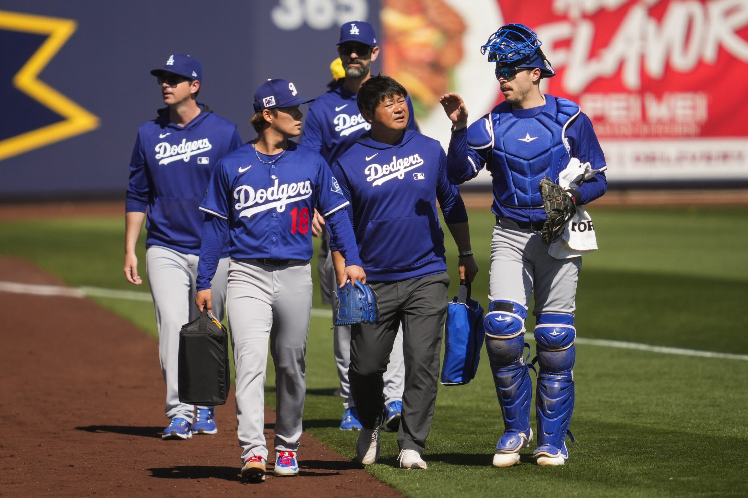 Dodgers starting pitcher Yoshinobu Yamamoto (18) and catcher Hunter Feduccia...