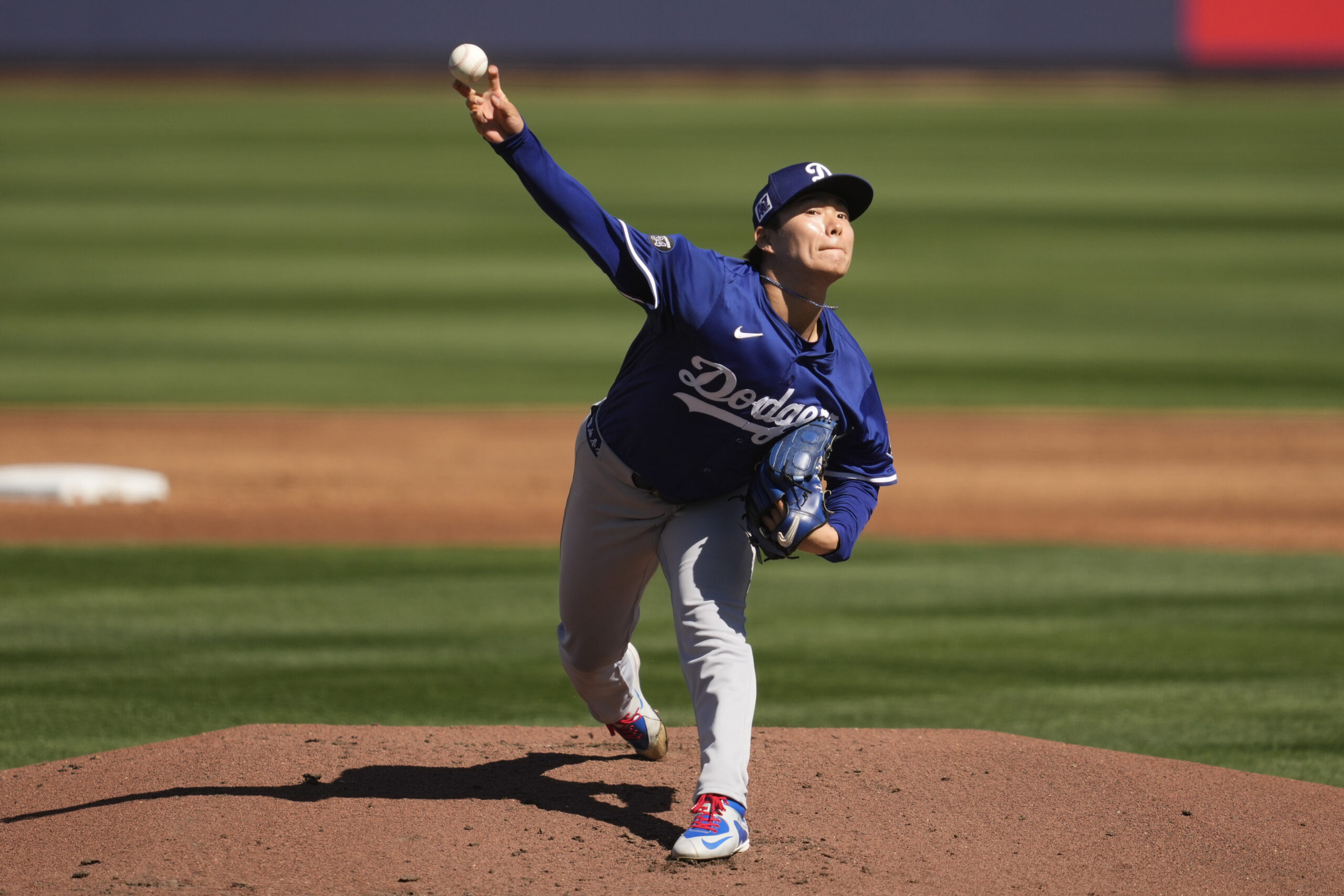 Dodgers starting pitcher Yoshinobu Yamamoto throws during the first inning...