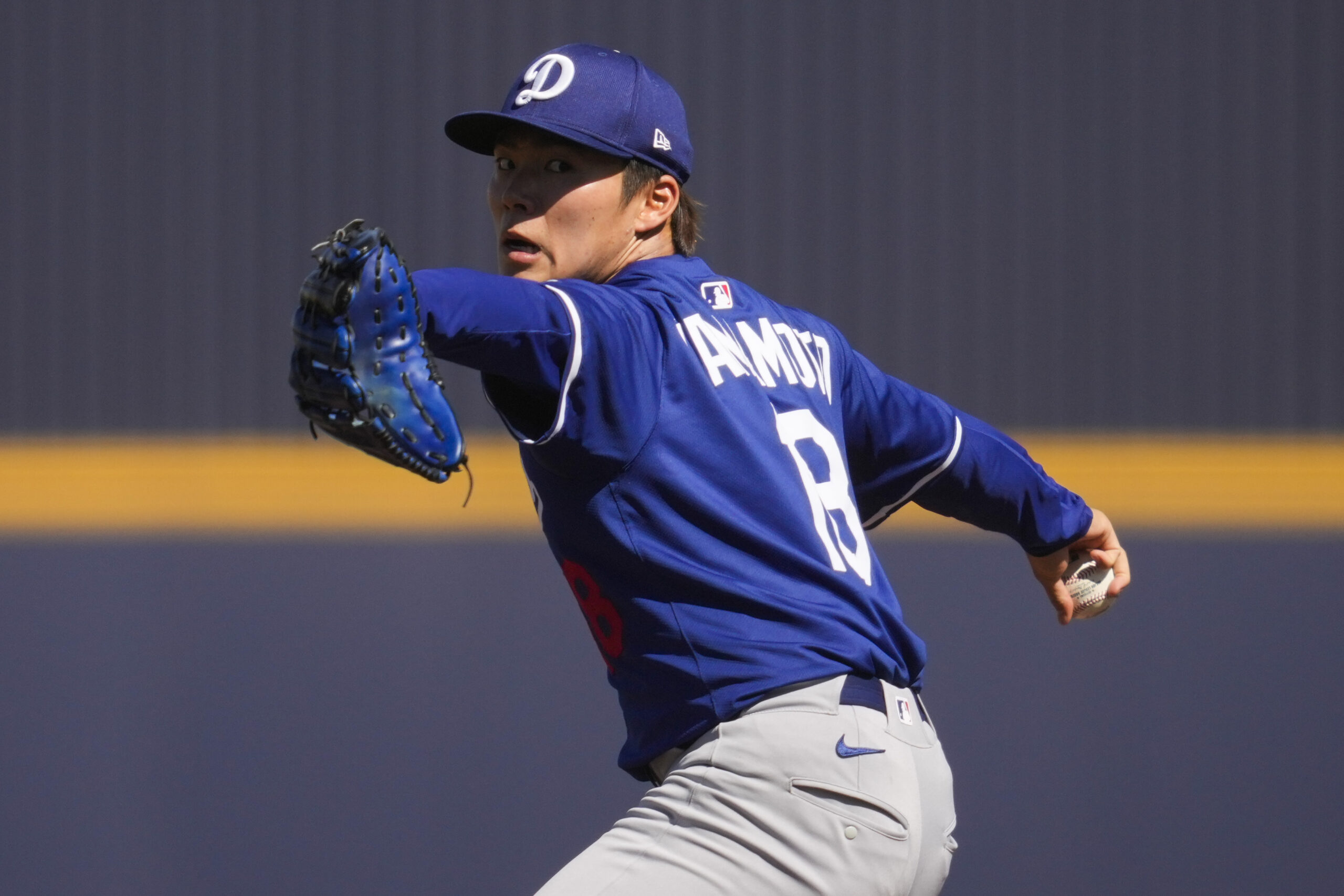 Dodgers starting pitcher Yoshinobu Yamamoto throws during the second inning...