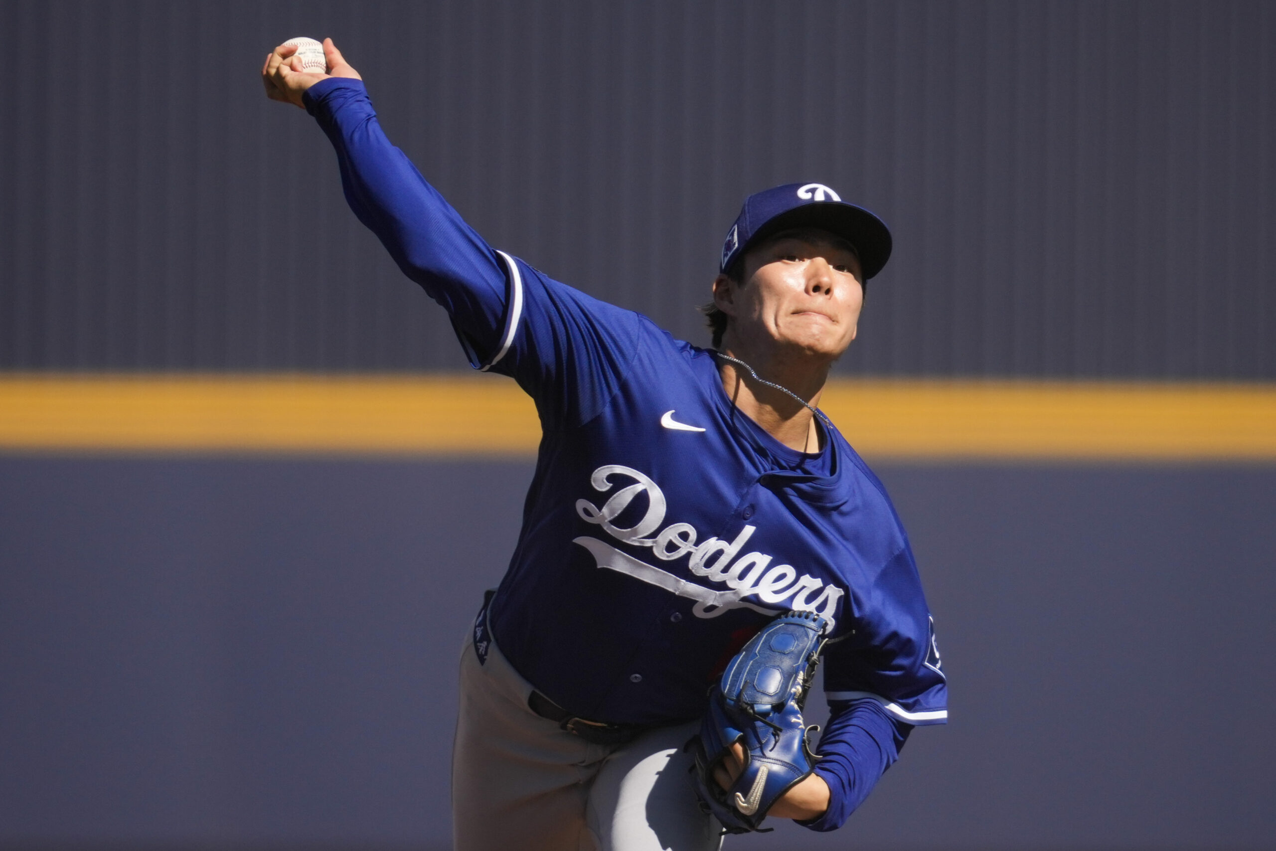 Dodgers starting pitcher Yoshinobu Yamamoto throws during the second inning...